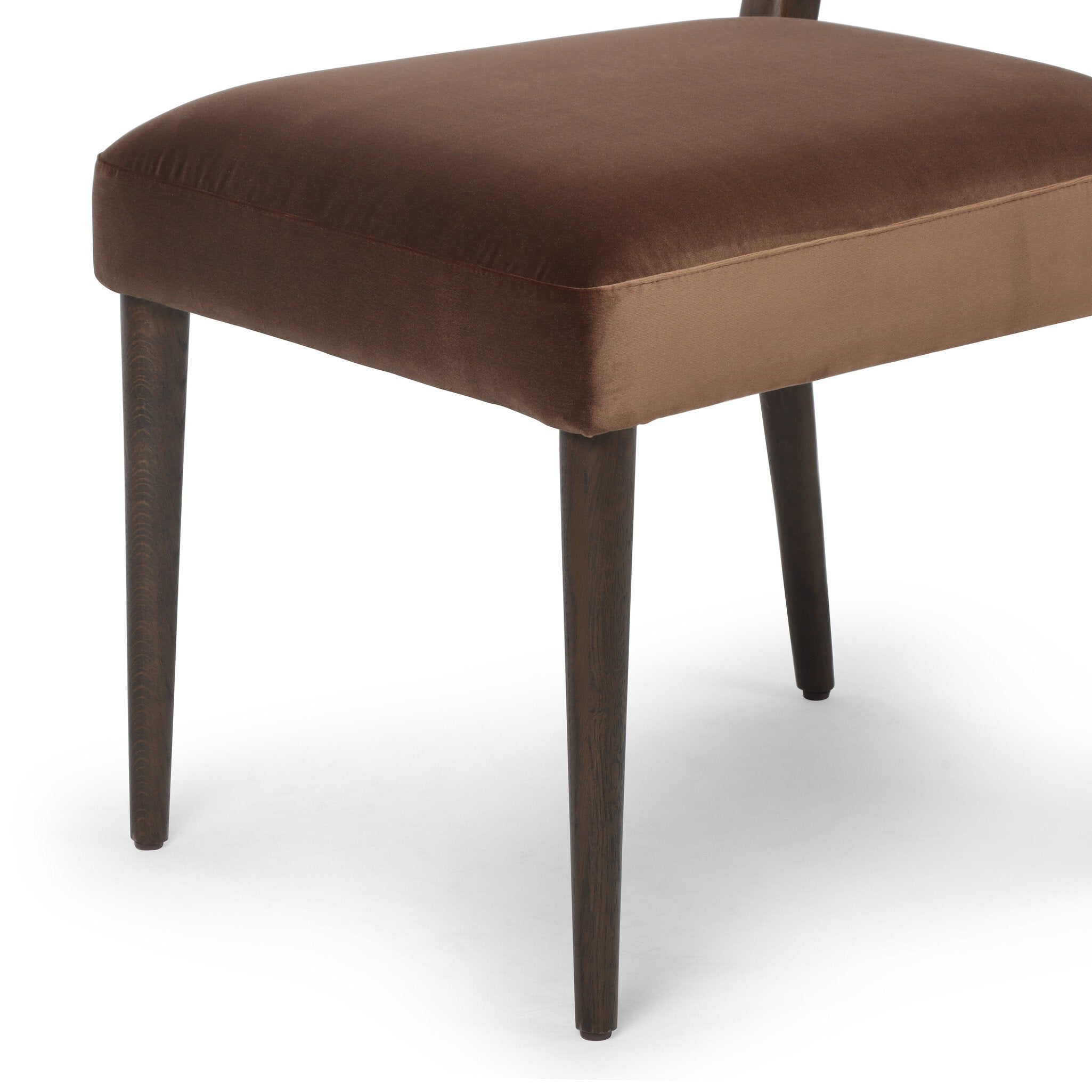 Brown cushioned dining chairl with wooden legs on a white background
