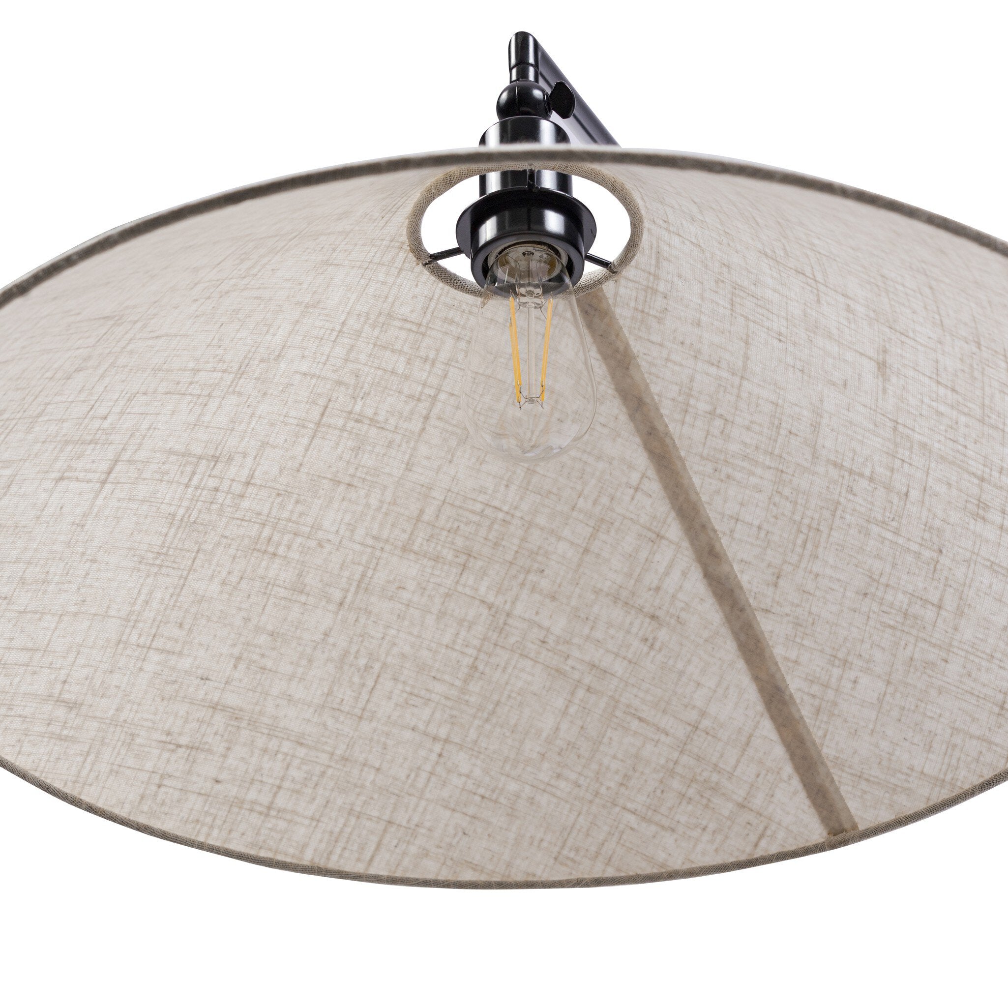 Close-up of a lamp with a beige fabric shade and metallic fixture