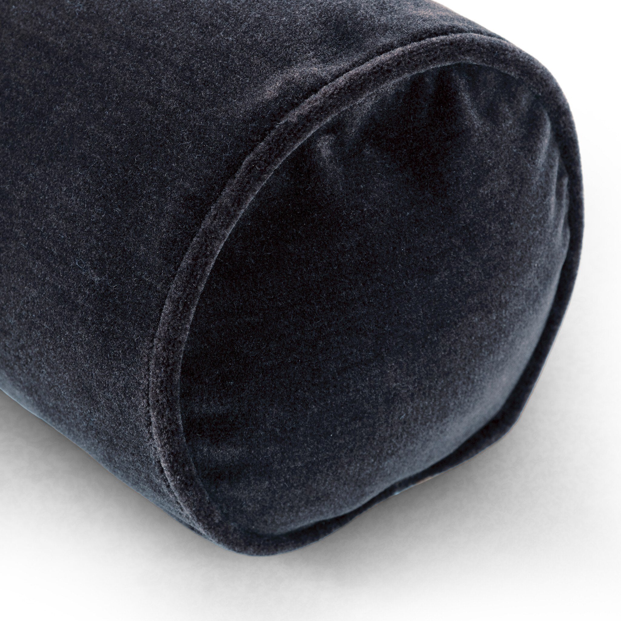 Close-up of a rolled-up dark gray fabric on a white background
