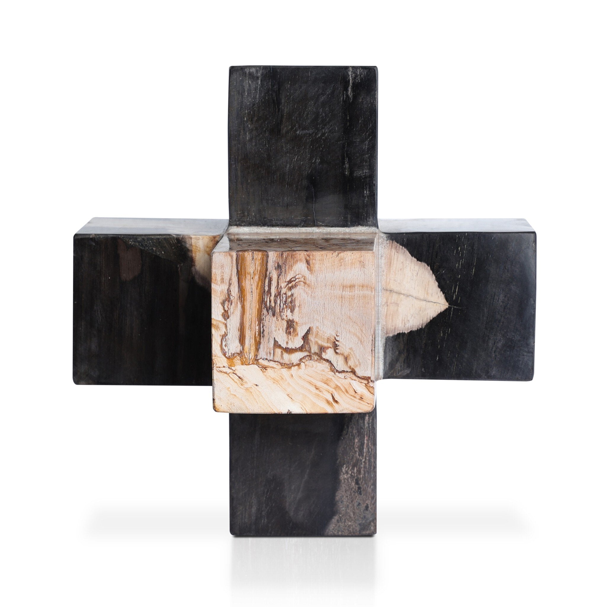 Geometric decorative object made from dark petrified wood on a white background