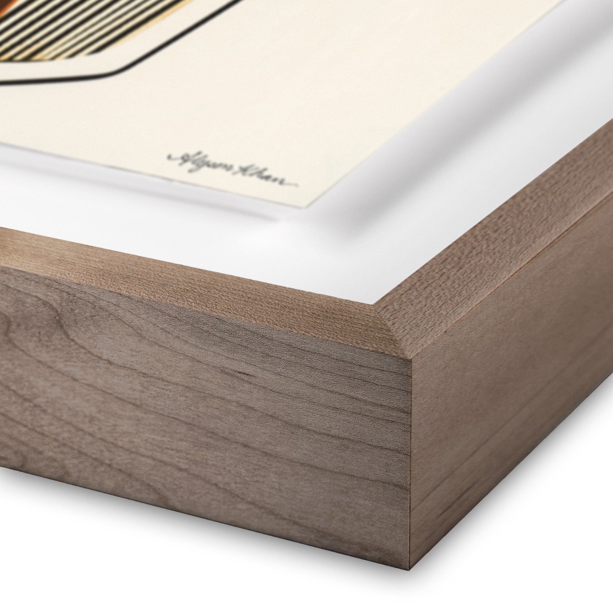 Close-up of a wooden picture frame corner with a white mat and artwork inside.