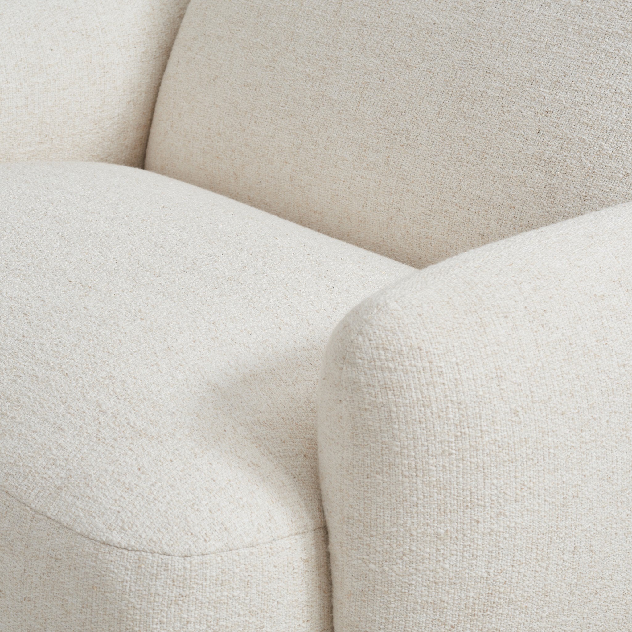 Close-up of a beige fabric sofa with a soft texture.