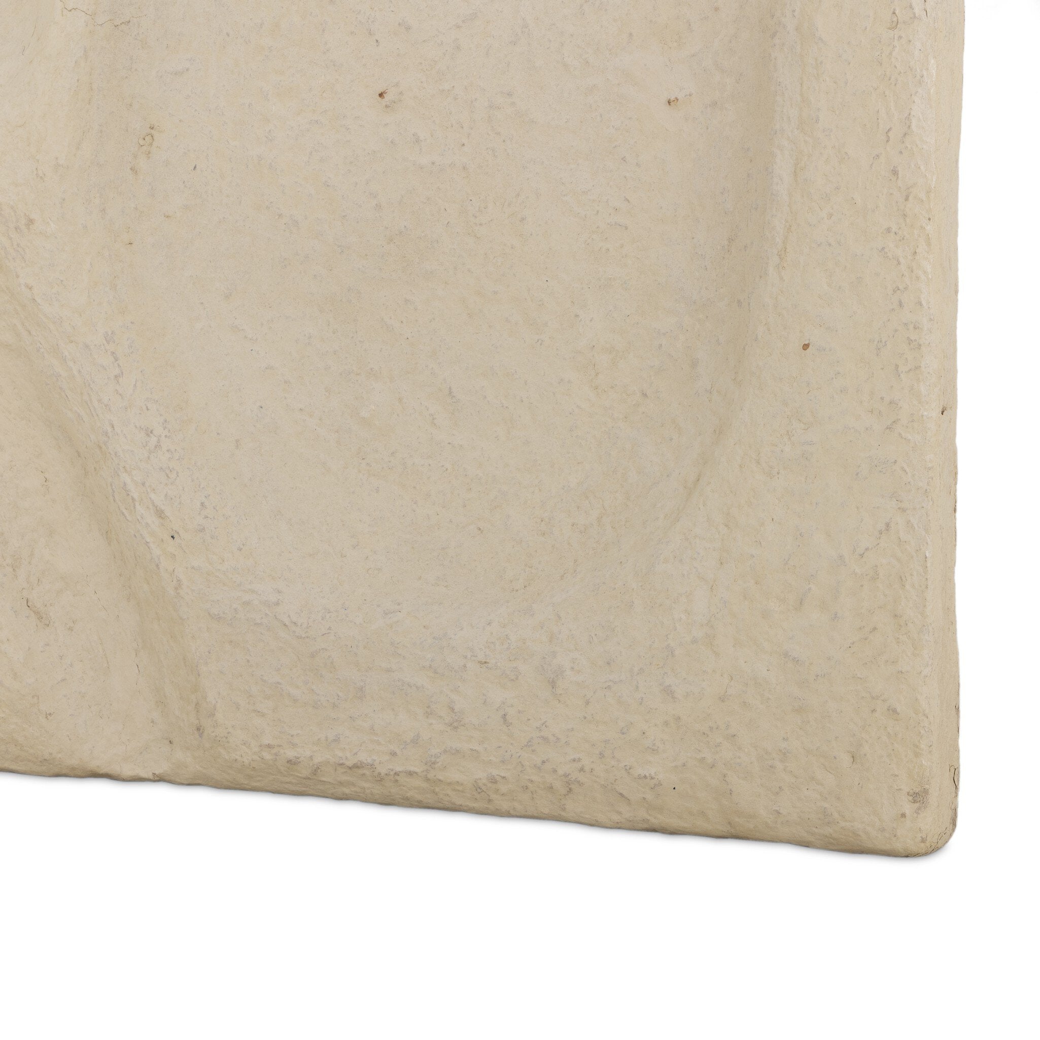 Close-up of a beige stone surface with natural texture