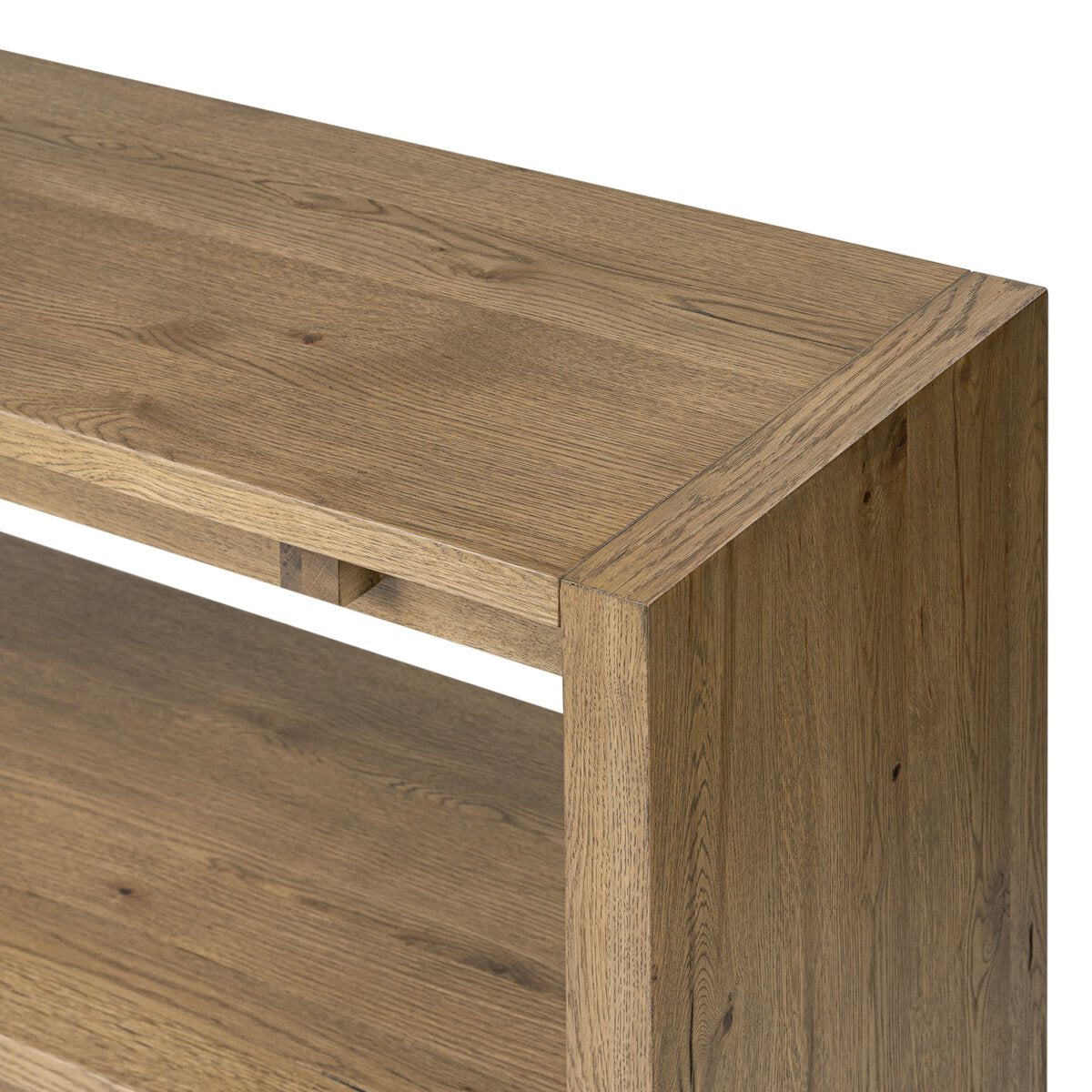 Wooden desk corner with a light brown finish on a white background