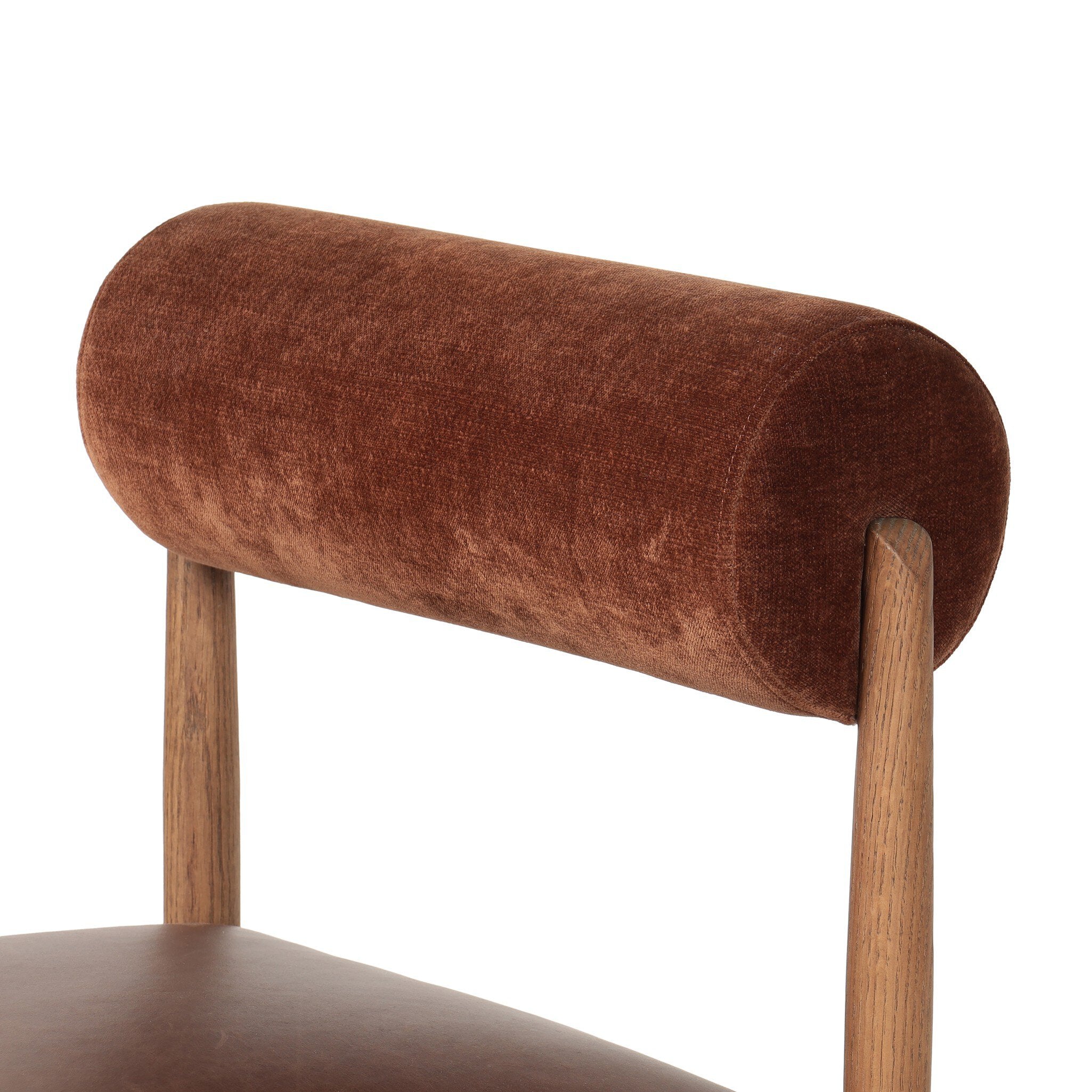 Brown cushioned chair with wooden legs on a white background