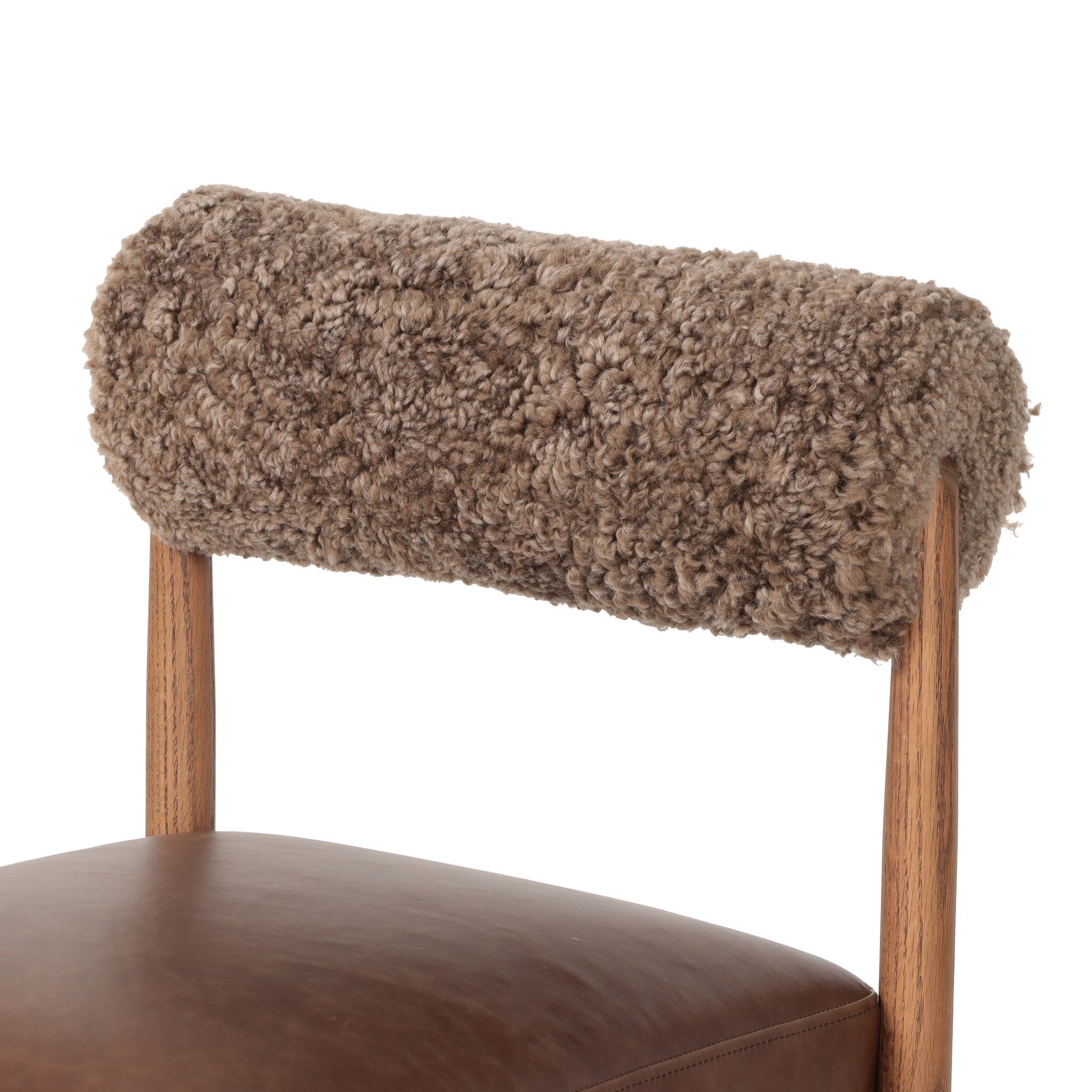 Chair with brown fur backrest and leather seat on a white background