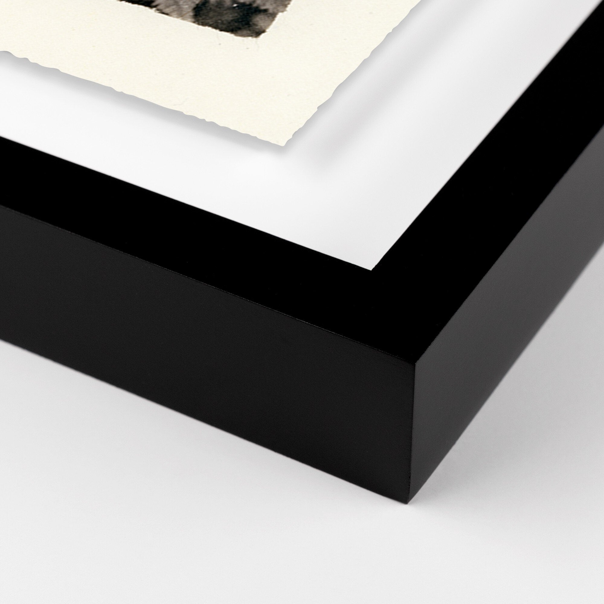 Close-up of a black picture frame corner on a white background