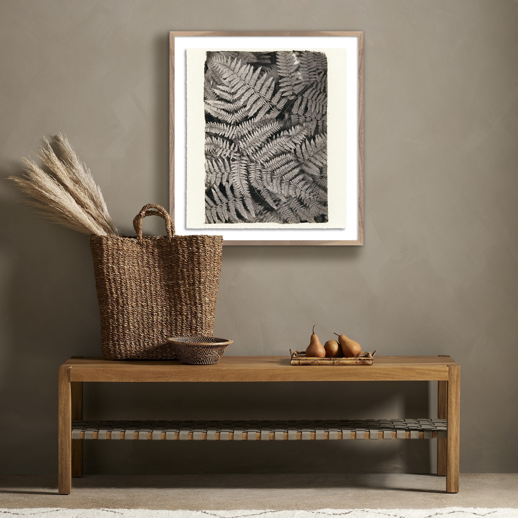 Wooden bench with decorative items against a wall with framed artwork