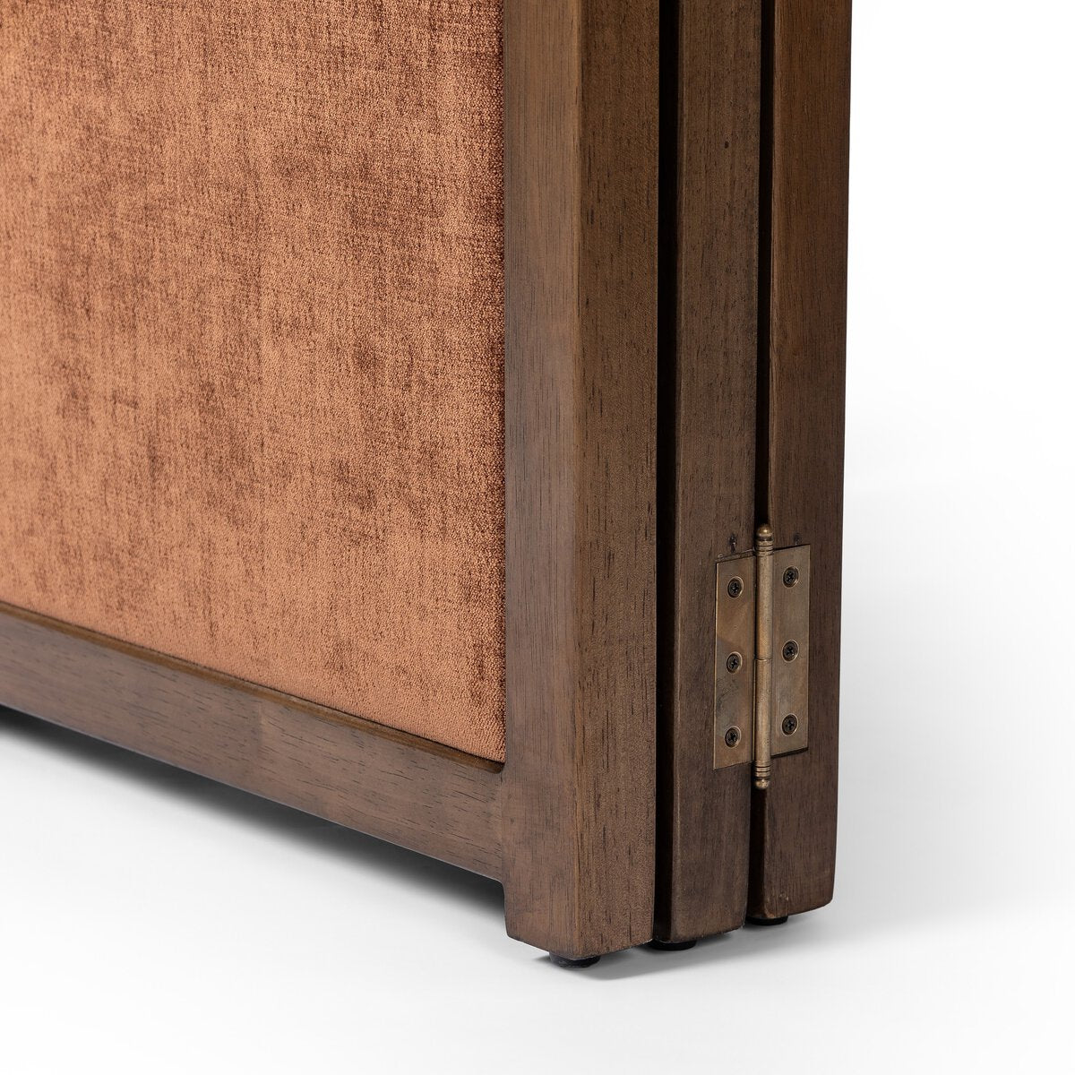 Close-up of a wooden room divider with a metal hinge on a white background