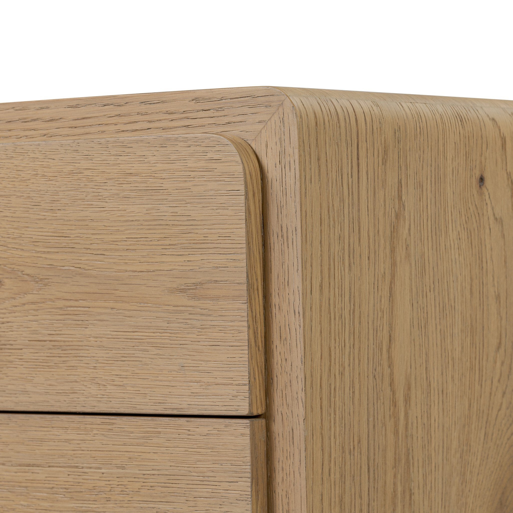 Close-up of a wooden drawer with a light finish on a white background