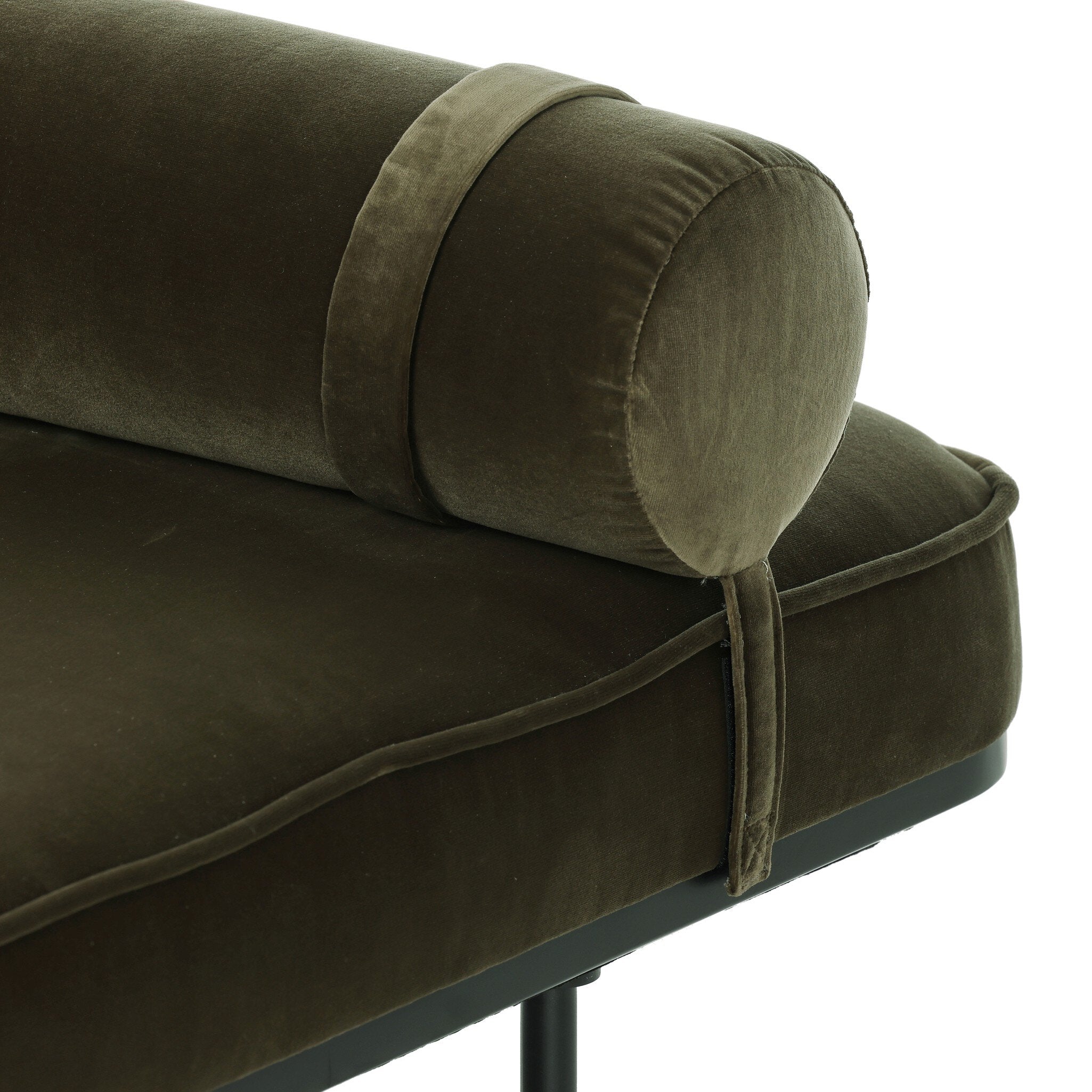 Close-up of a green velvet chaise with a decorative lumbar pillow on a white background