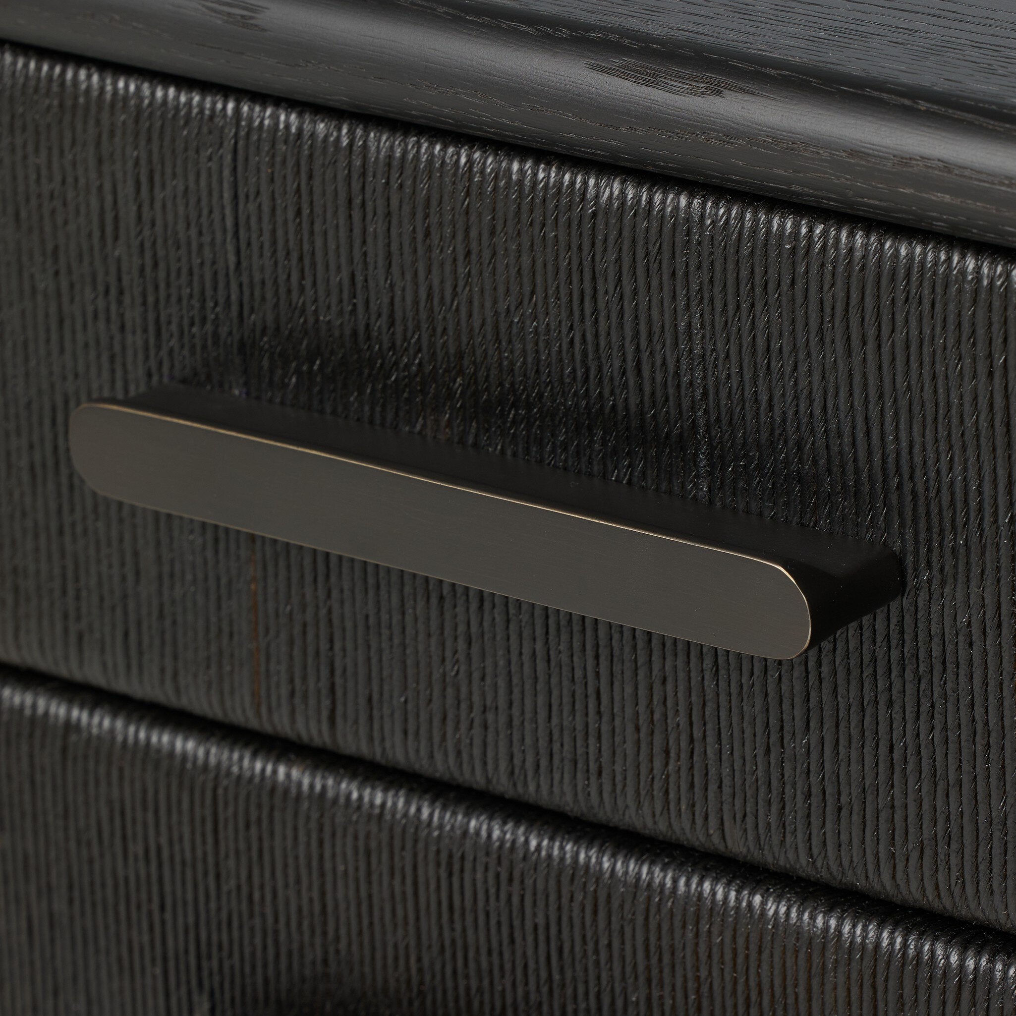 Close-up of a black textured drawer with a handle