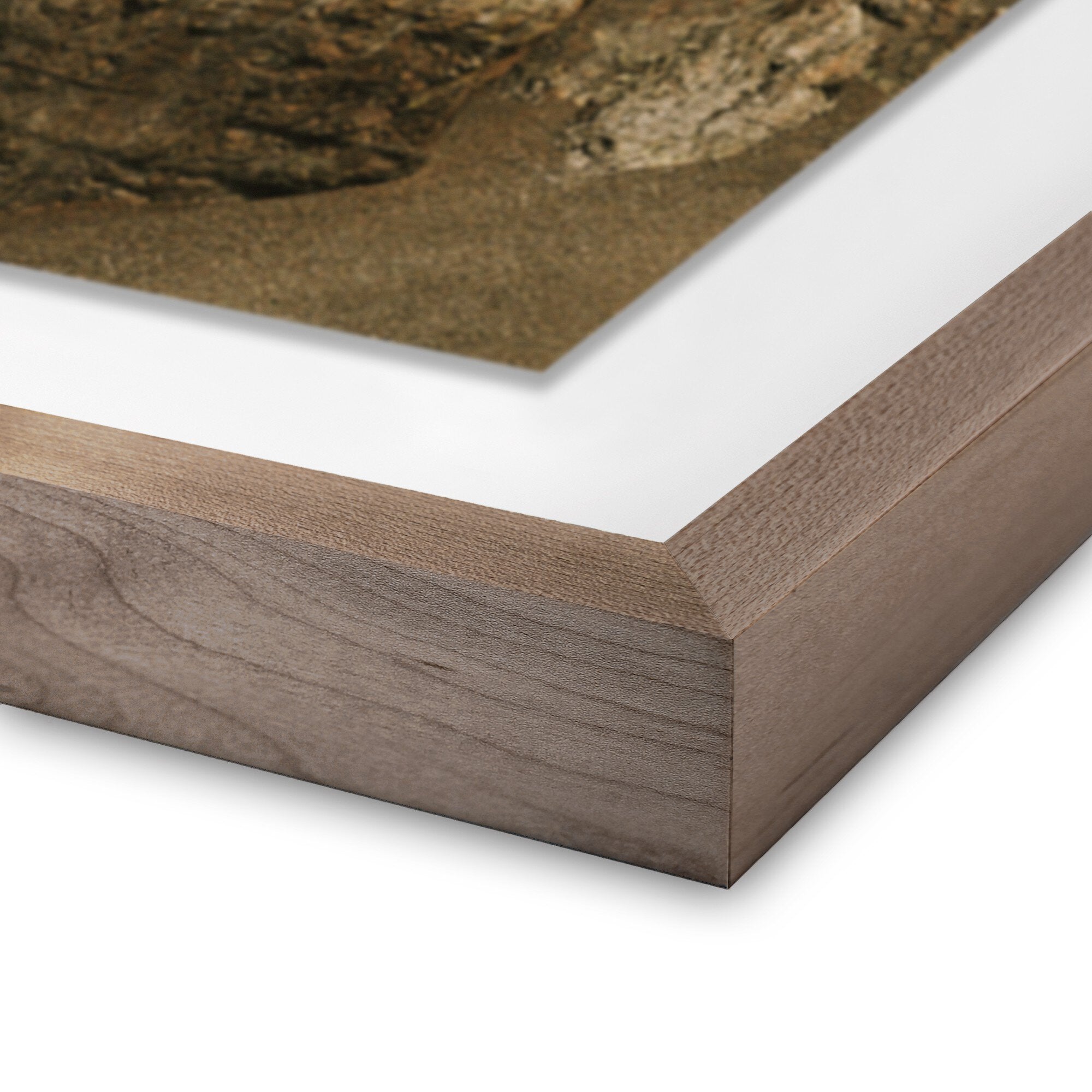 Close-up of a wooden picture frame corner with a textured wall background