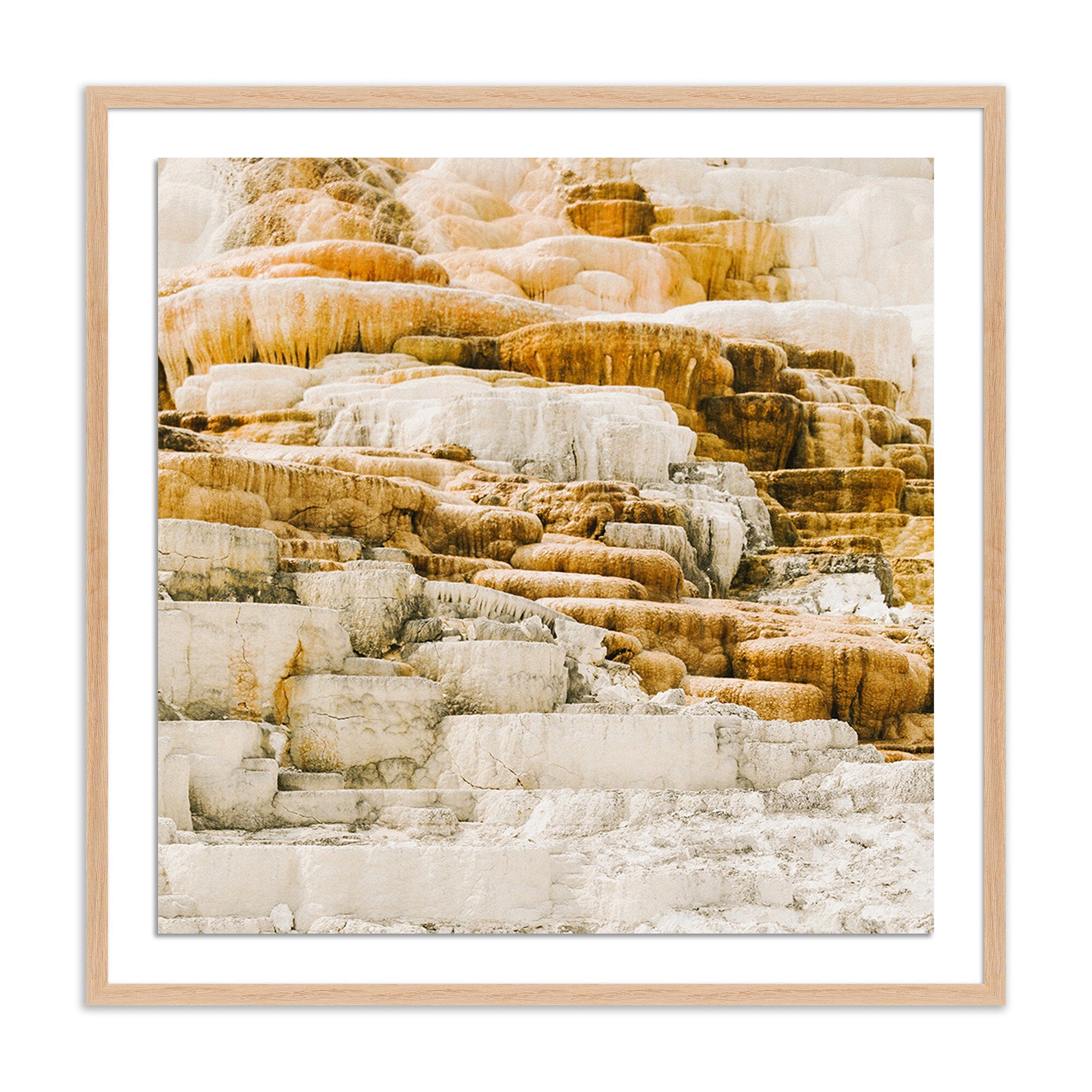 Framed photograph of layered rock formations with a wooden frame