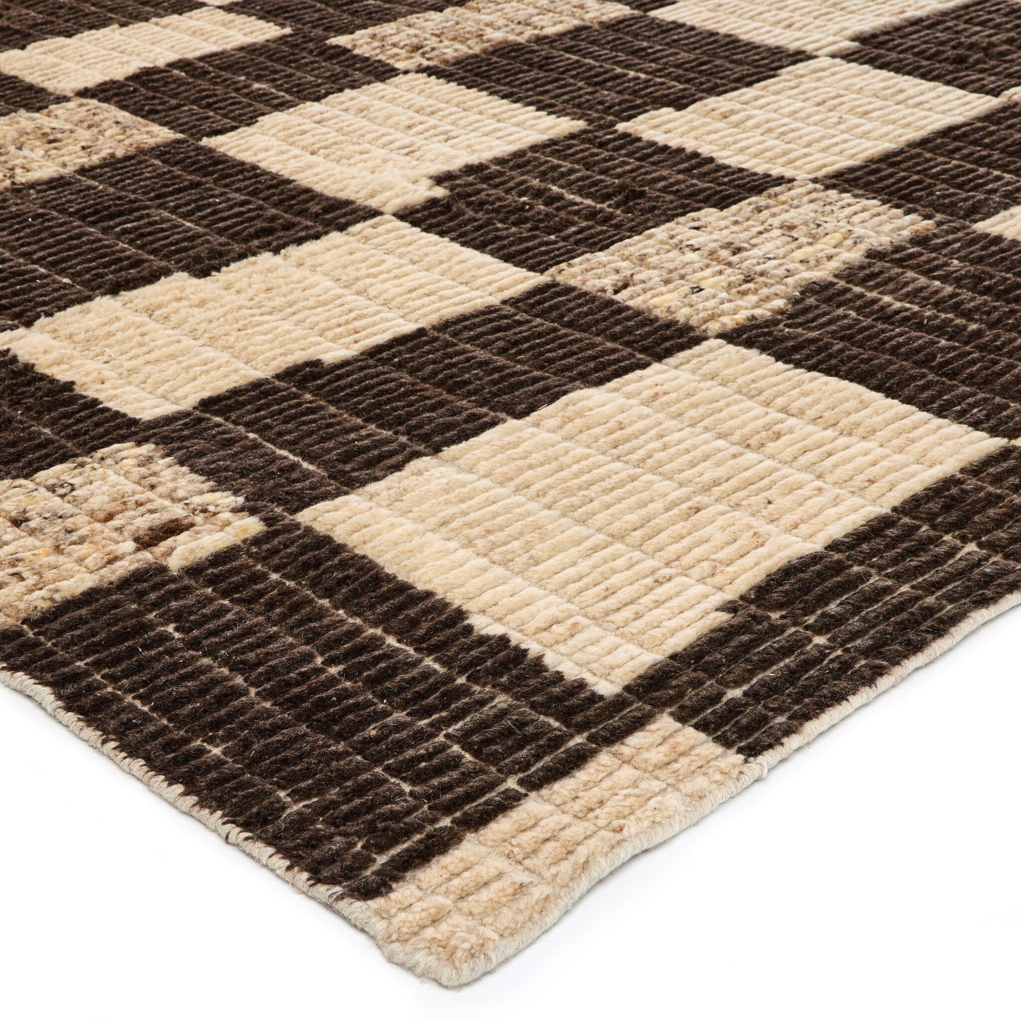Close-up of a checkered rug with brown and beige squares