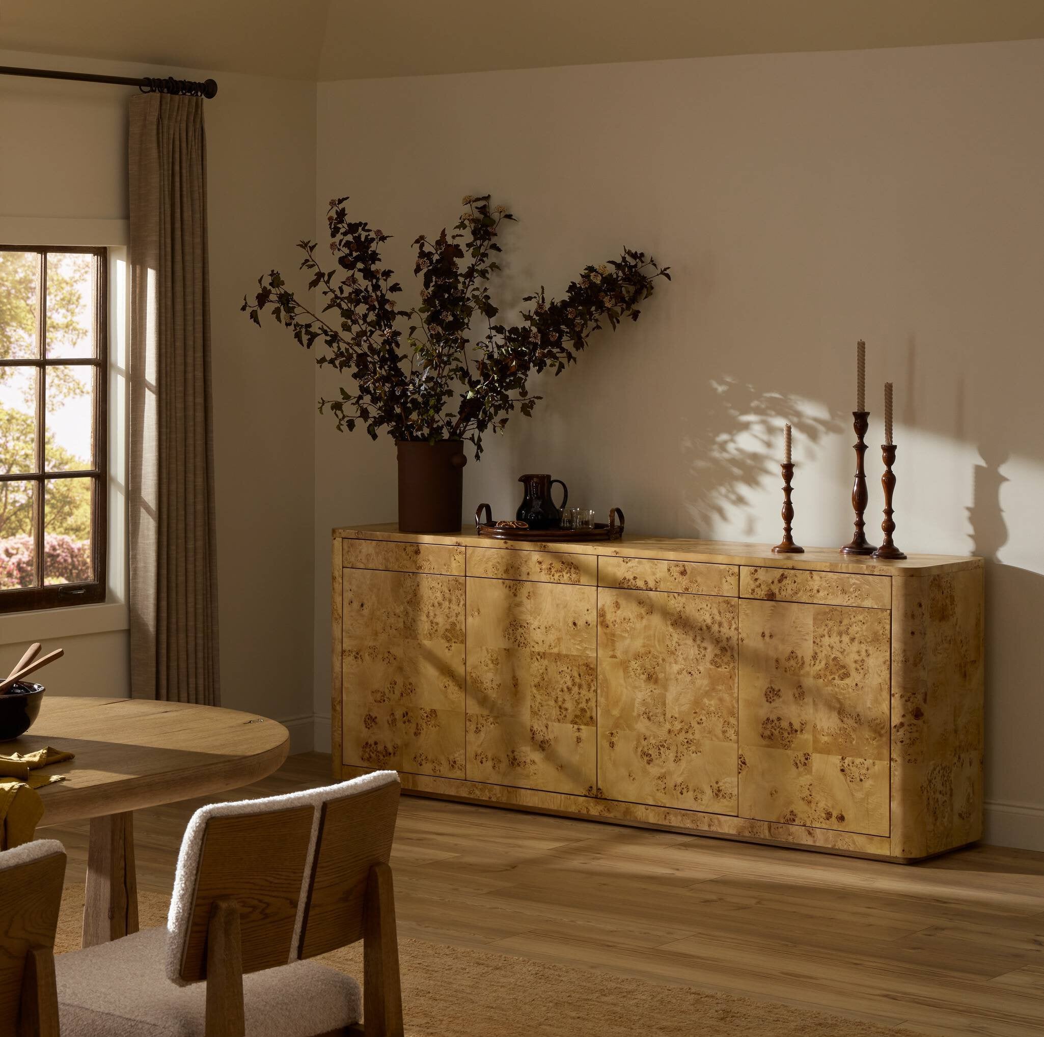 Dining room with a wooden sideboard, table, and chairs.