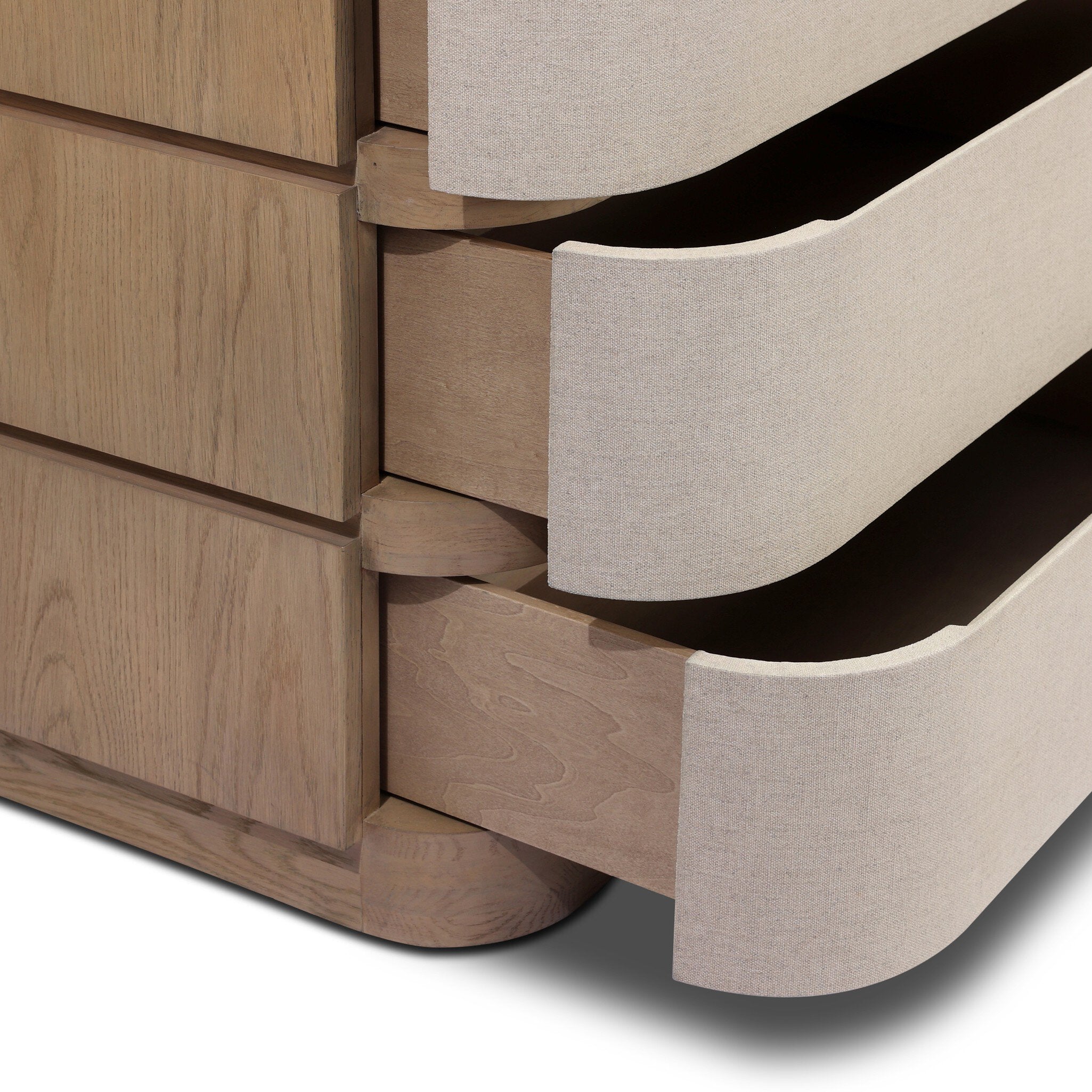 Close-up of a wooden drawer with a beige fabric panel