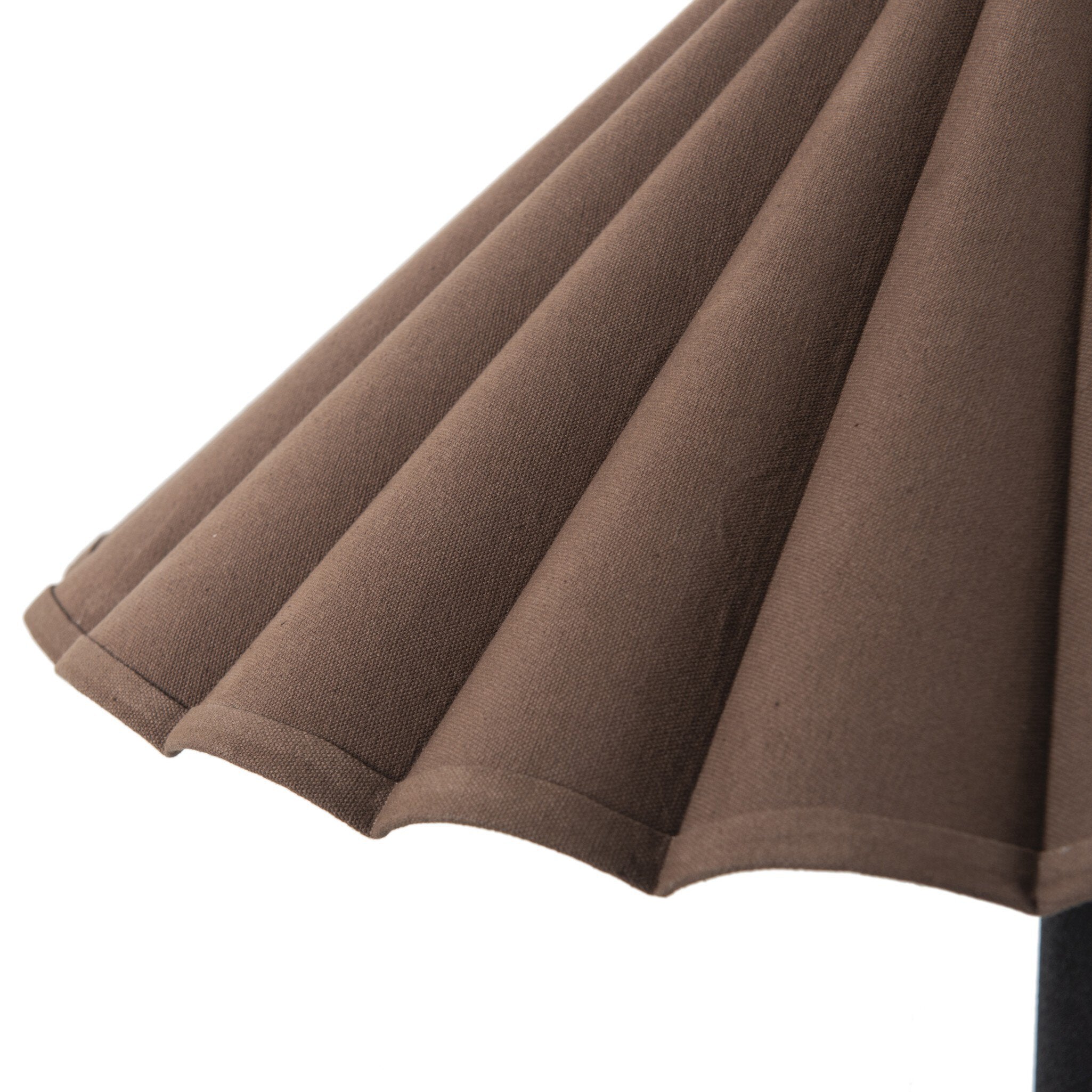 Close-up of a brown pleated lampshade on a white background
