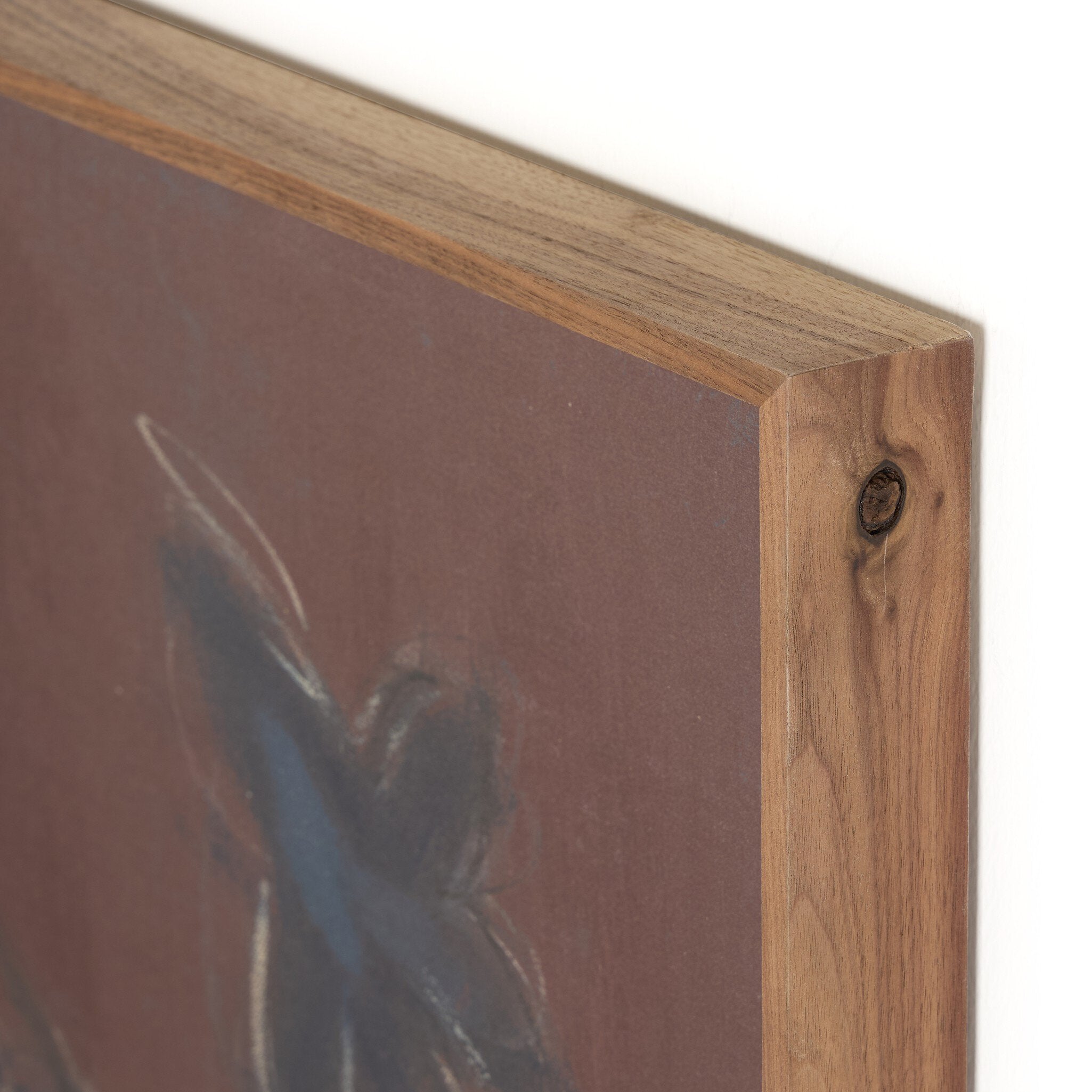 Wooden picture frame corner with a blurred painting inside