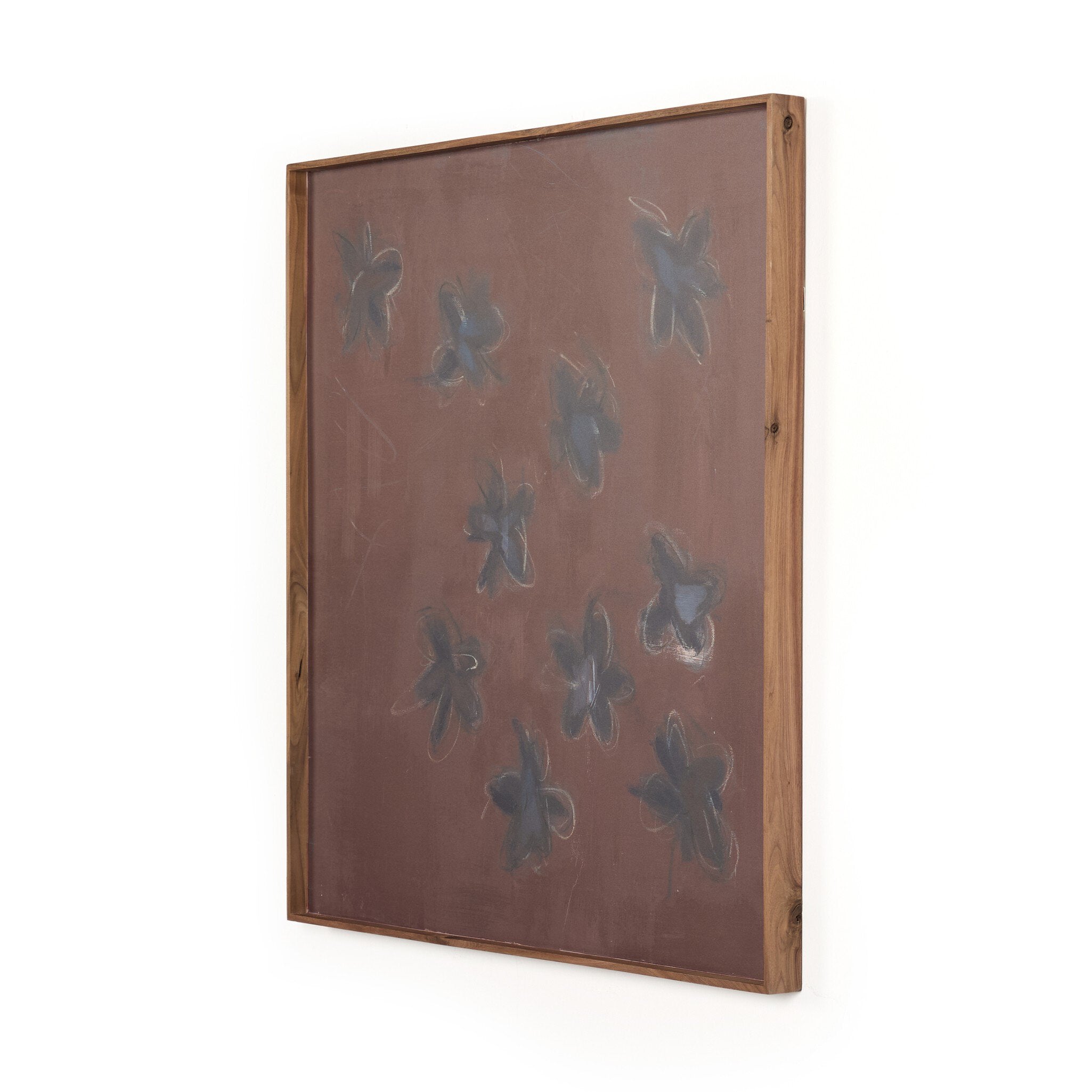 Decorative wall art with butterfly shapes on a brown background, framed in wood.