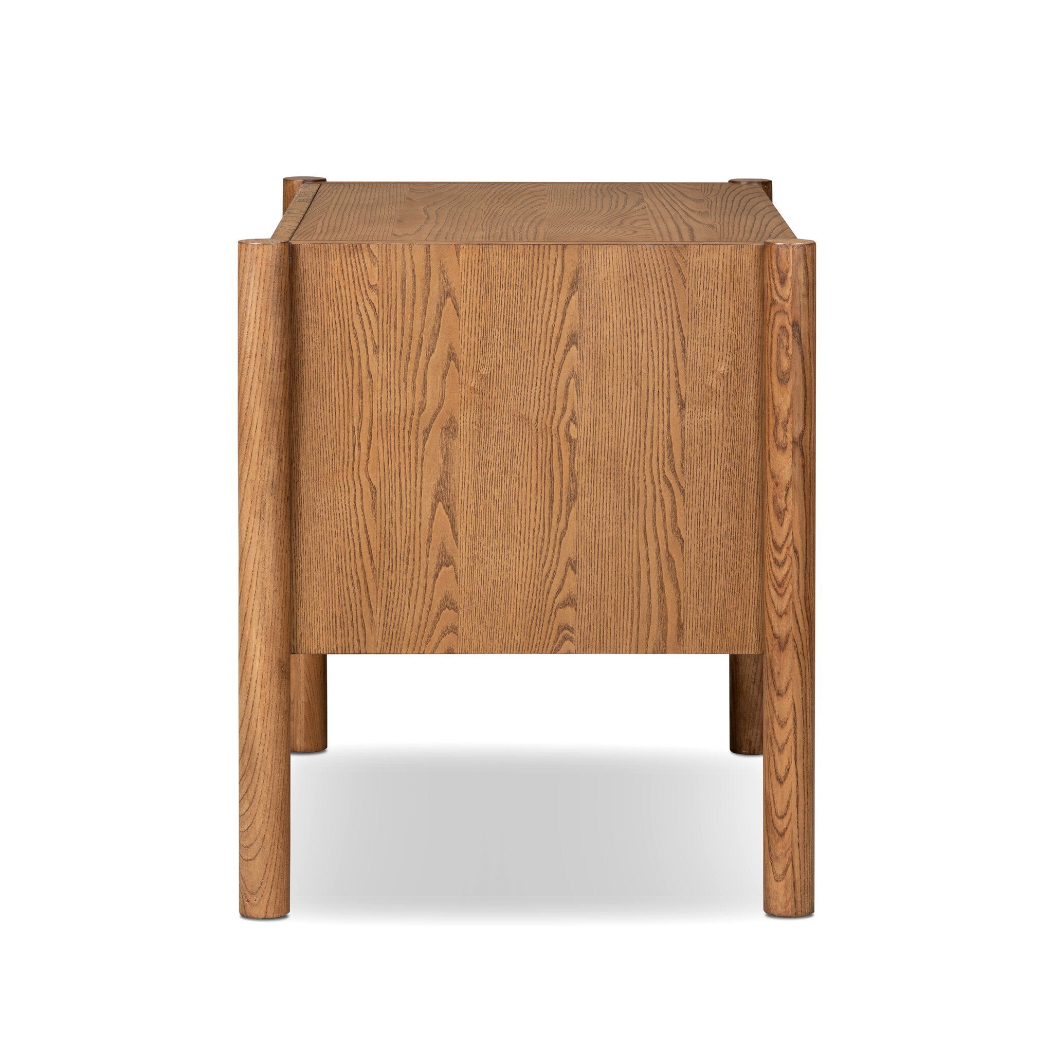 A mid-century modern wooden side table with a warm oak finish, featuring a rectangular front panel and tapered legs, shown from the back on a white background.