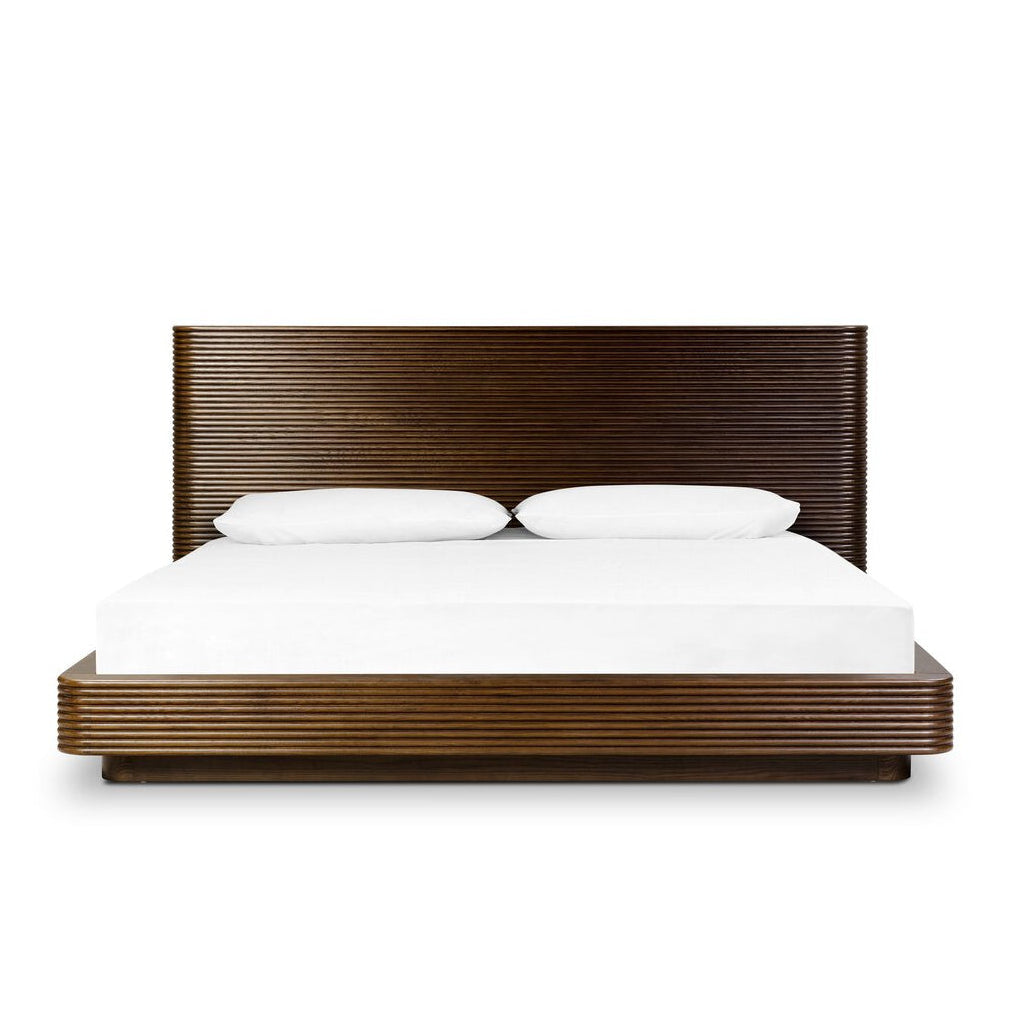 Wooden bed frame with white bedding on a white background
