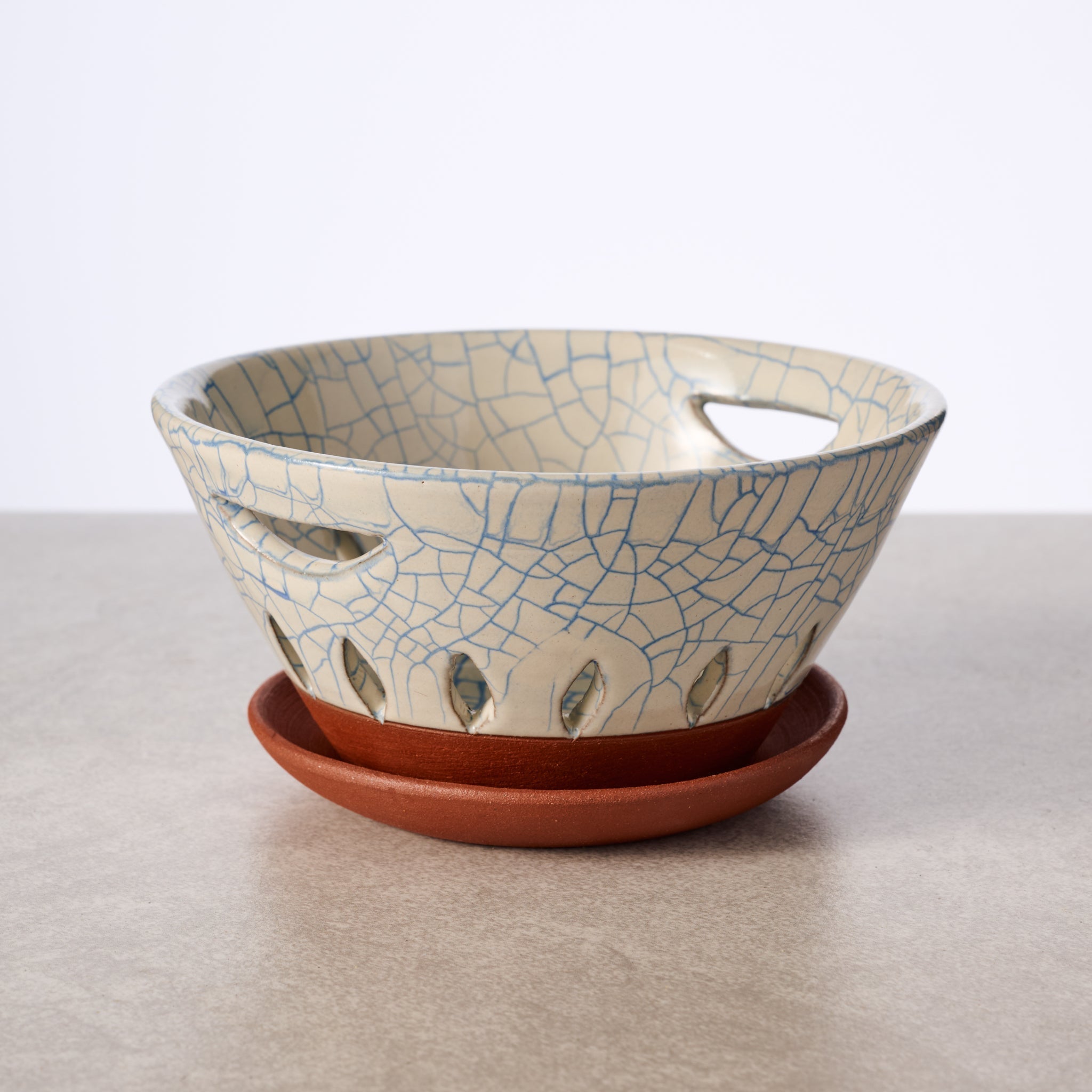 Ceramic berry bowl with cracked glaze design on a white background