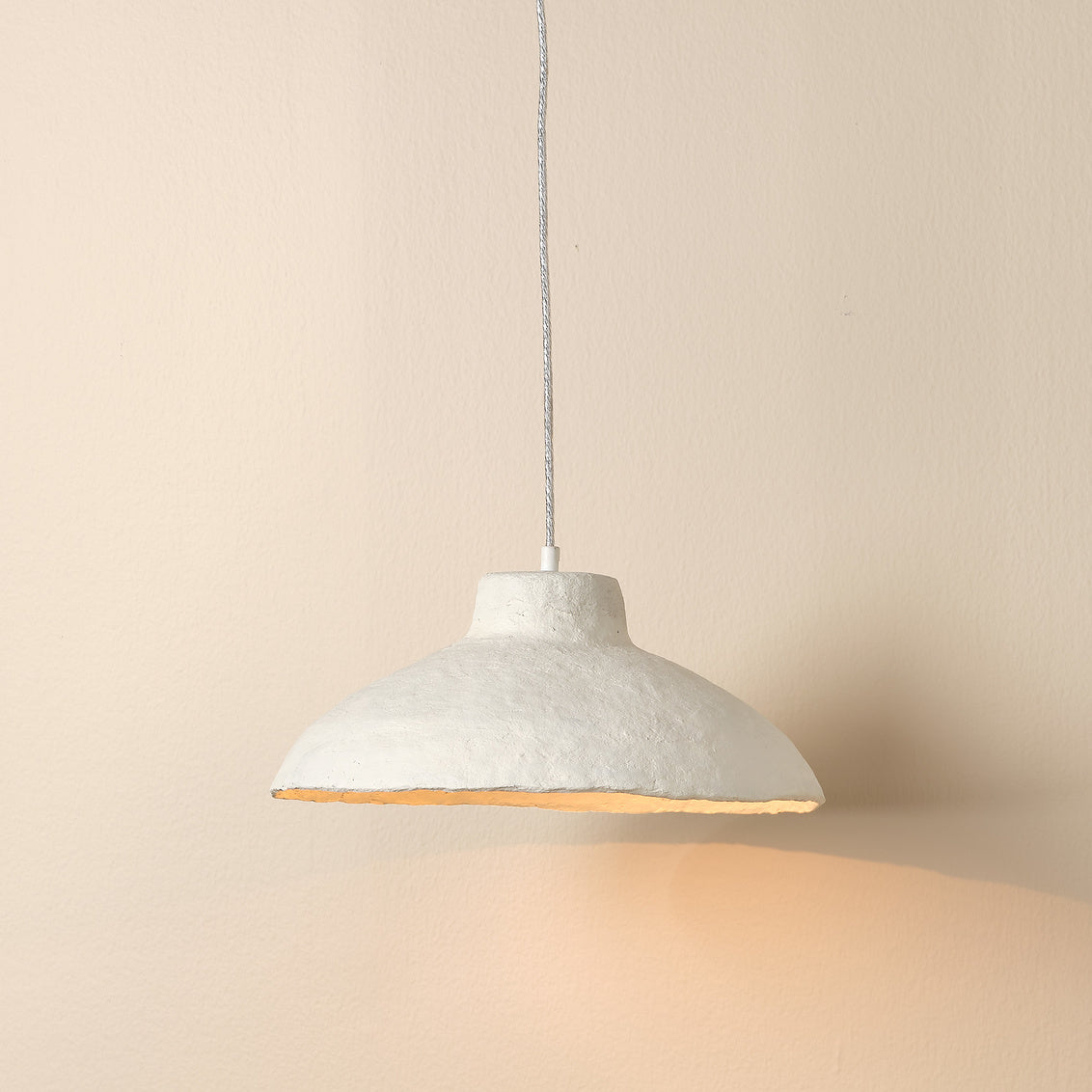 Concrete pendant light on a beige background