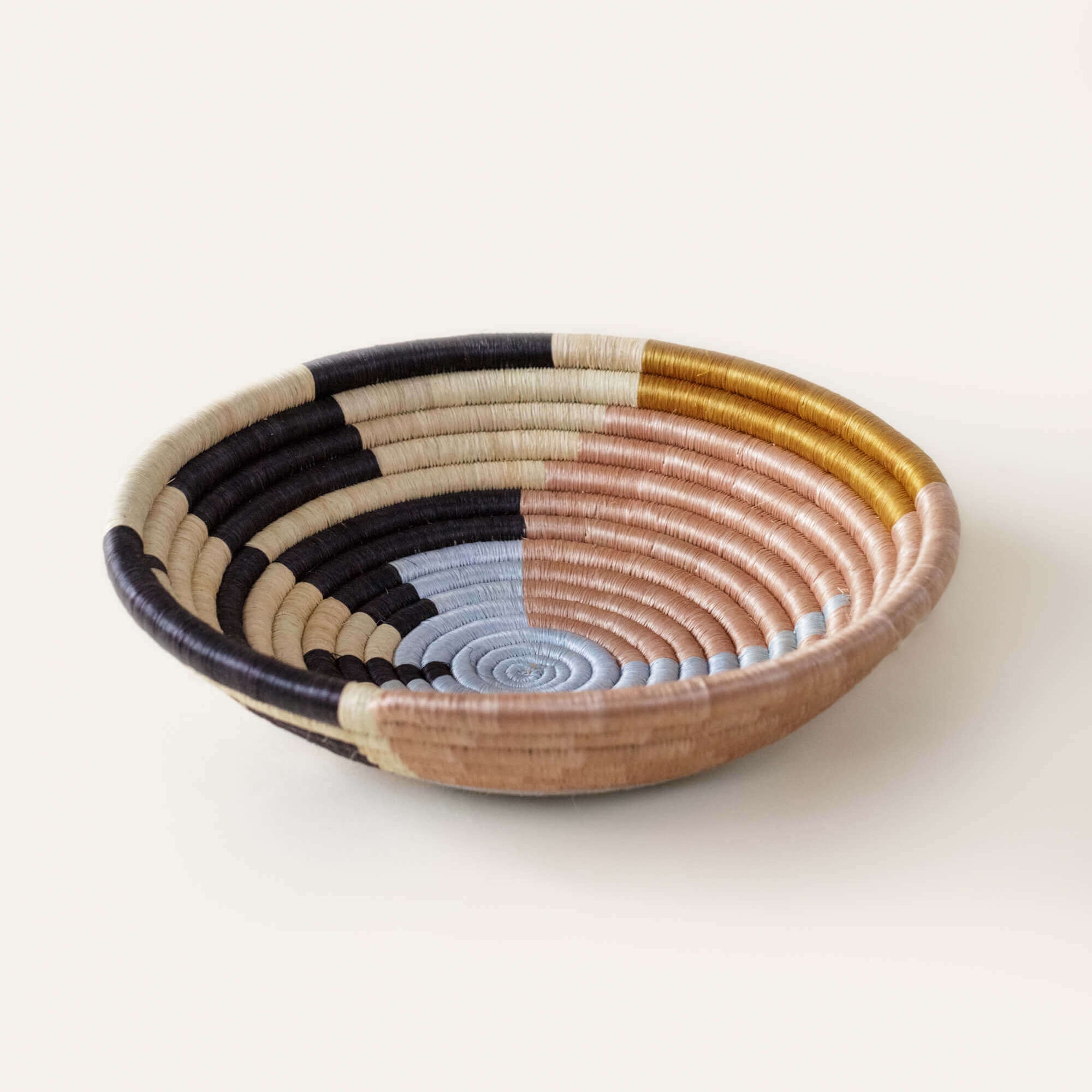 Woven bowl with multicolored pattern on a white background