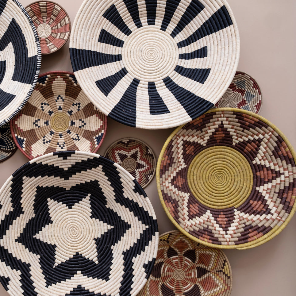 Collection of woven baskets with various patterns on a neutral background