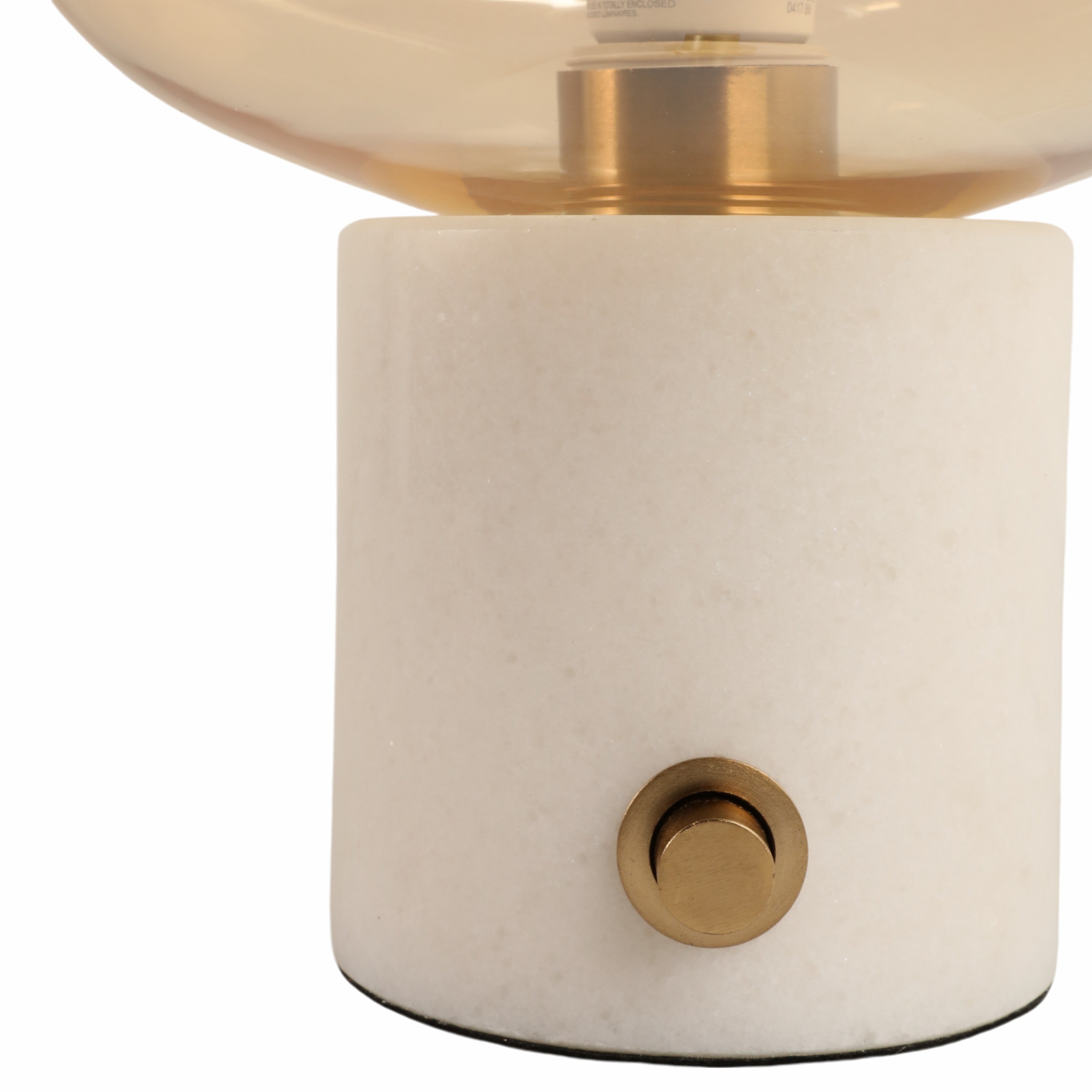 Table lamp with white base and gold accents on a white background