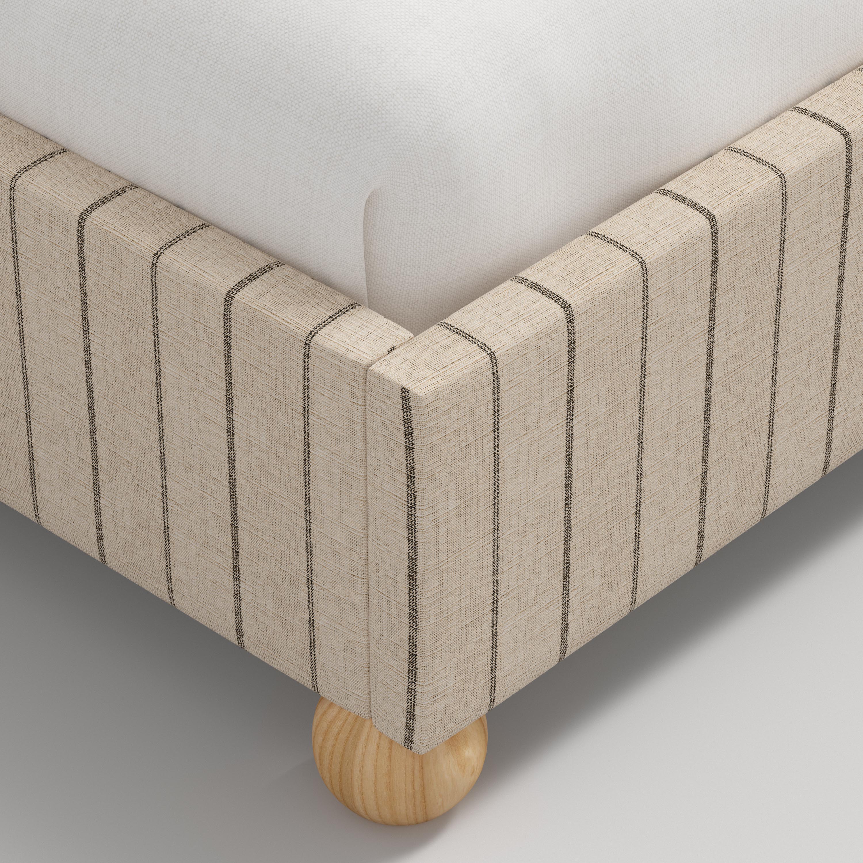 Beige bed with wooden legs and white bedding on a white background