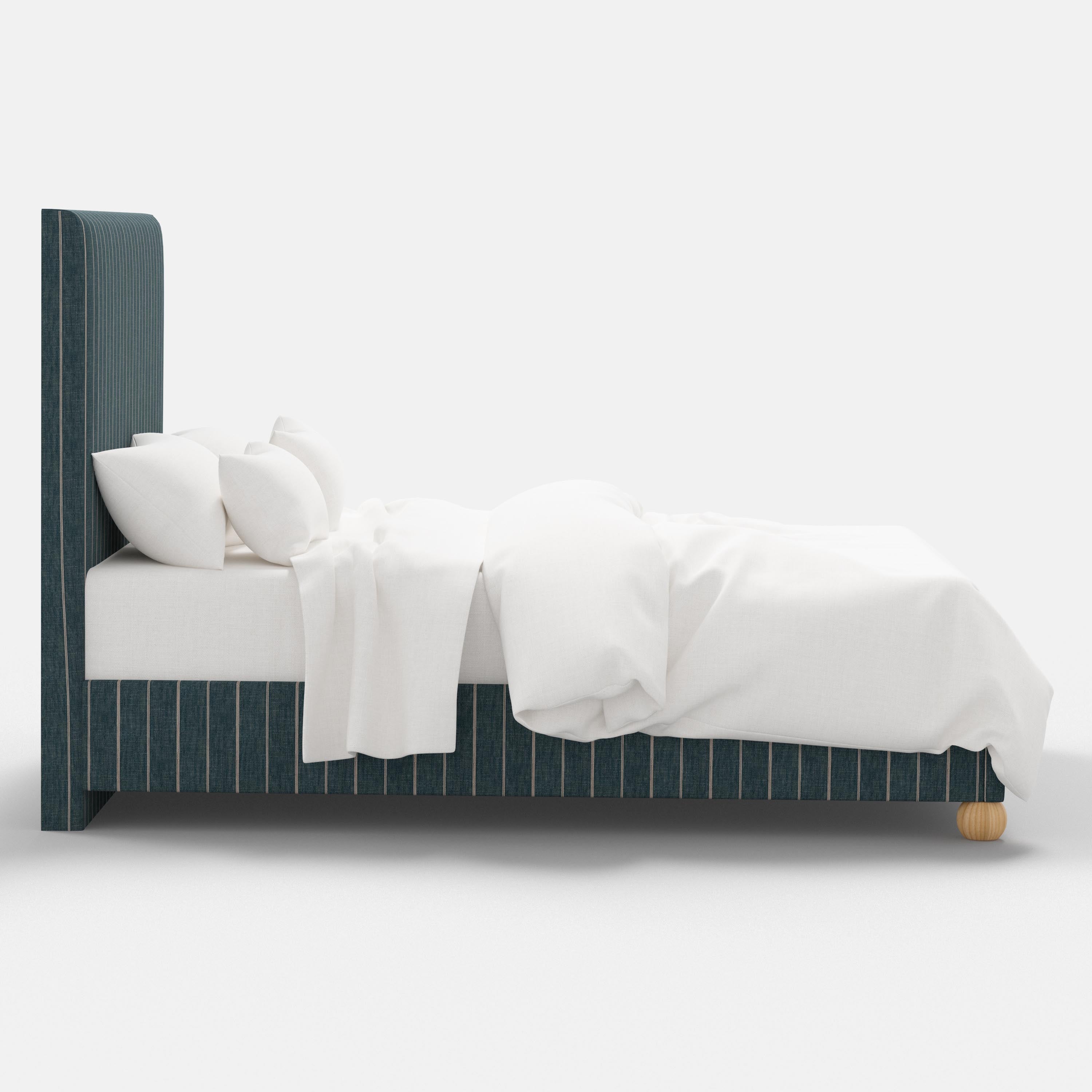 Bed with white bedding and a striped headboard on a white background