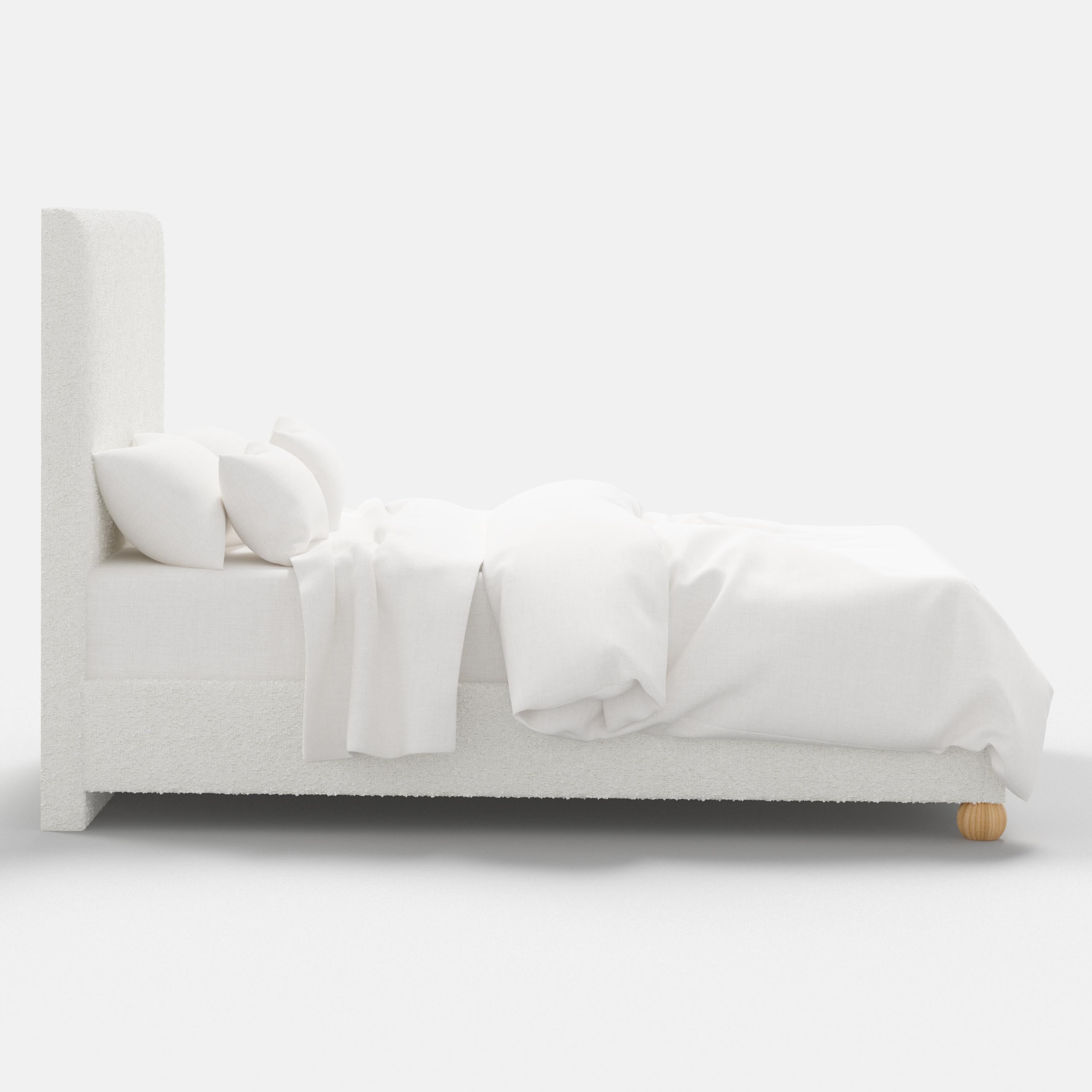 White bed with white bedding on a white background