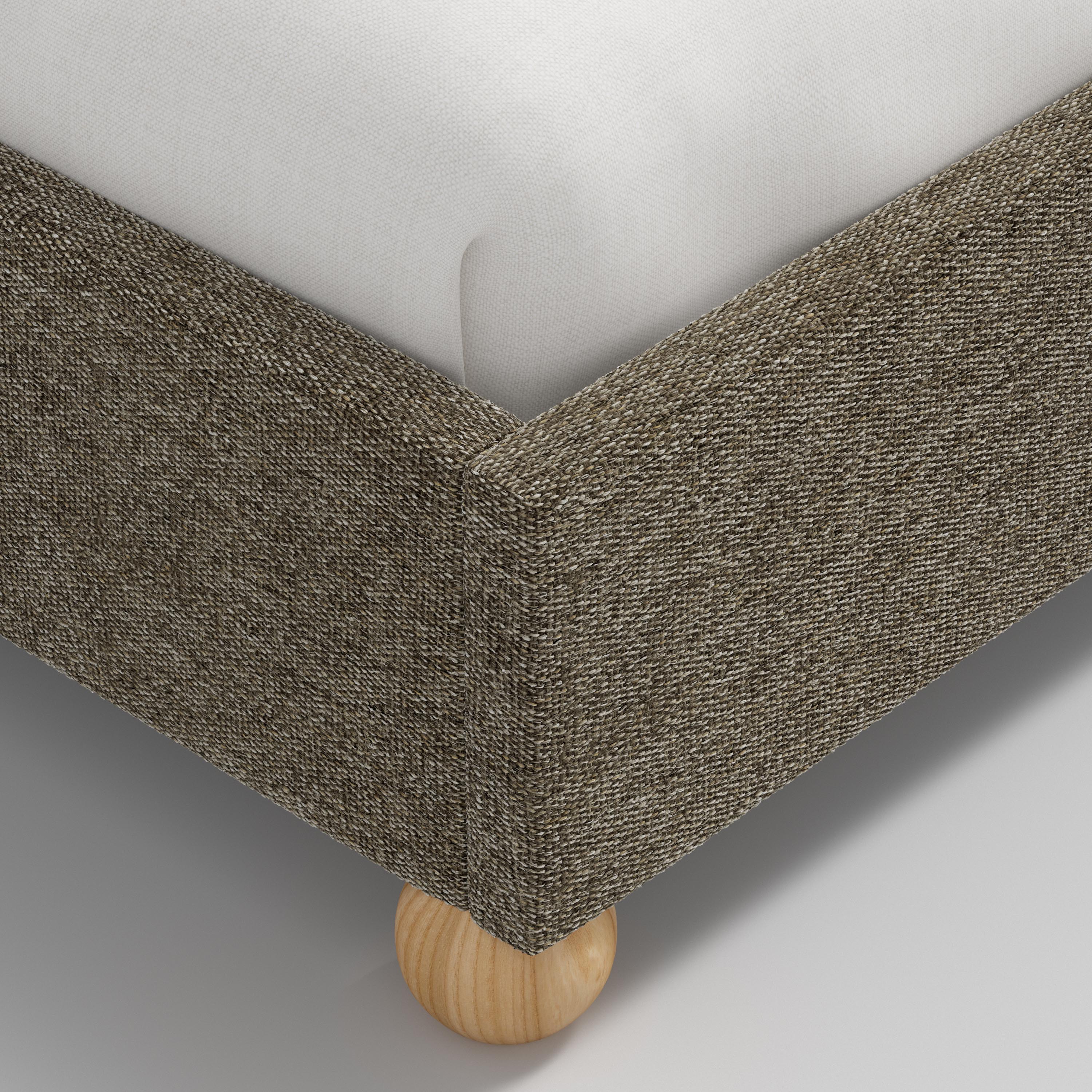 Bed with gray upholstered headboard and white bedding on a white background