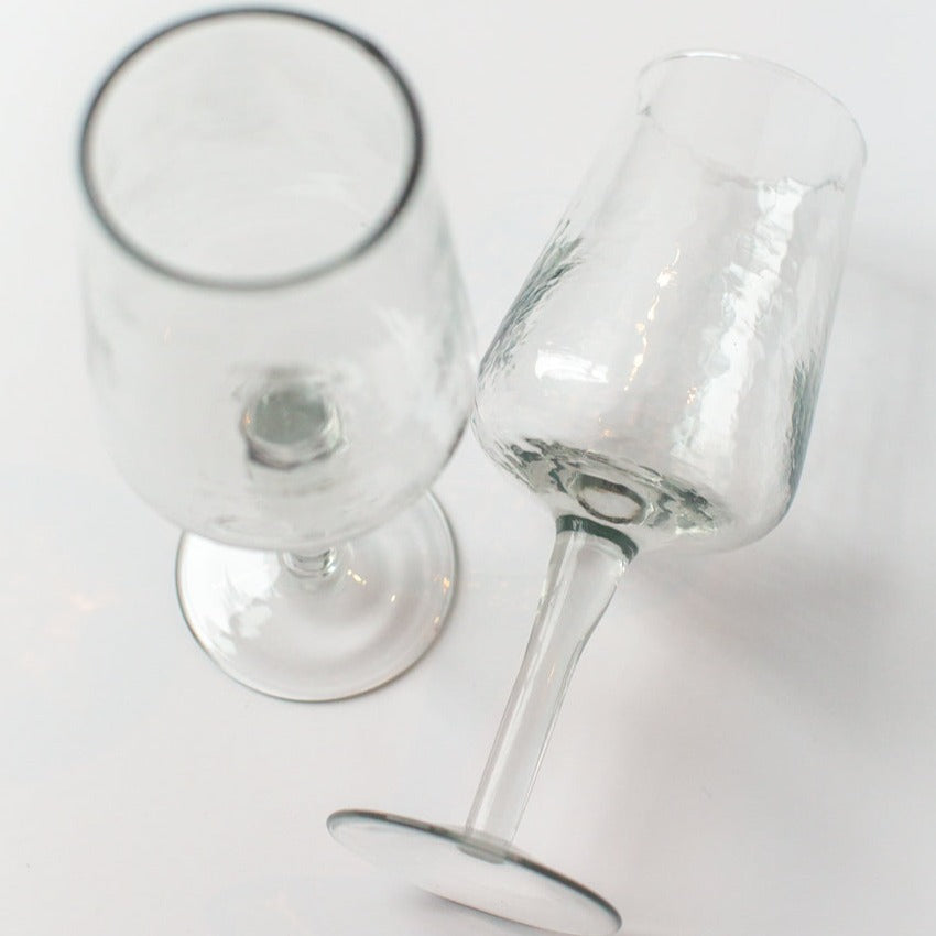 Two clear wine glasses on a white background