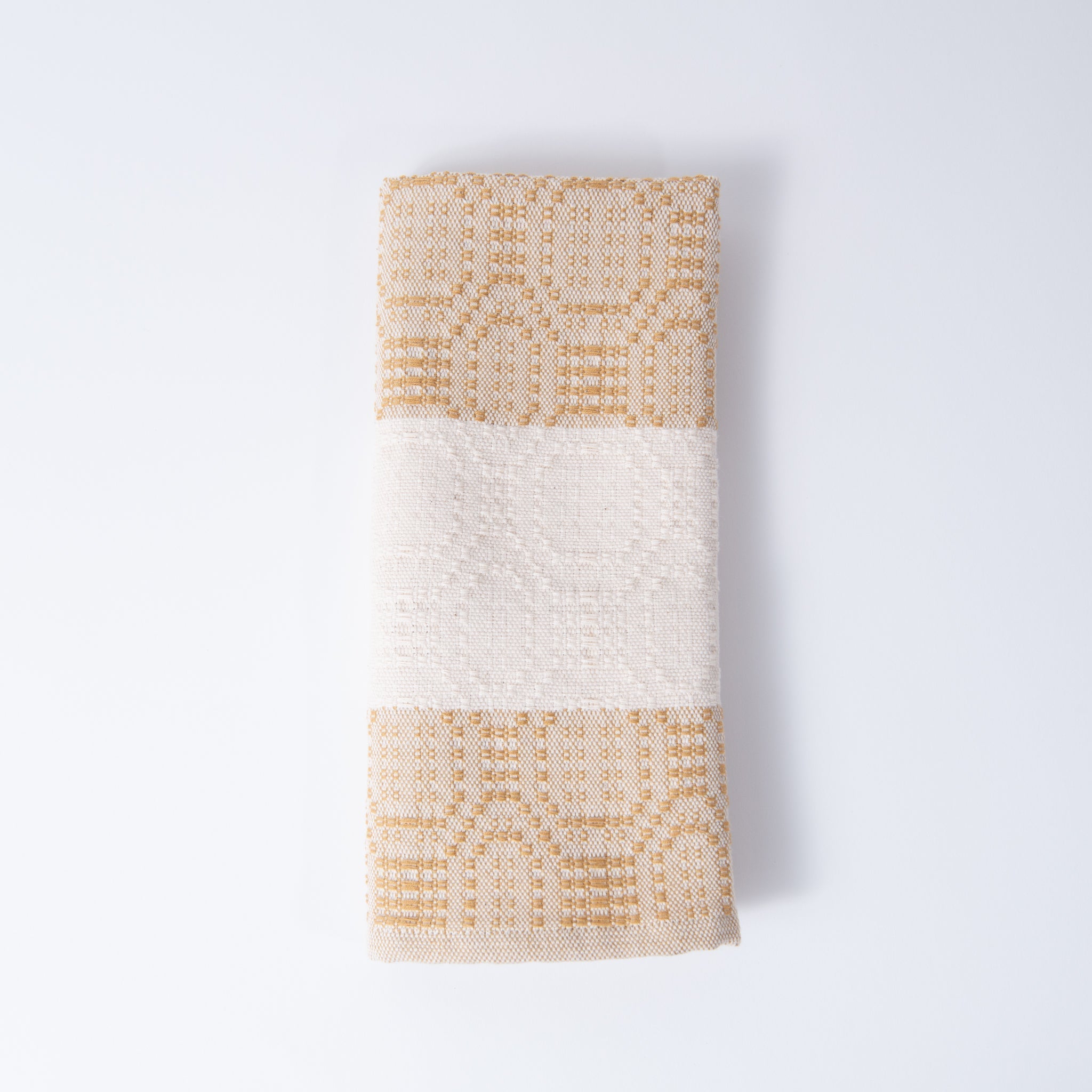 Textured towel with geometric pattern on a light gray background