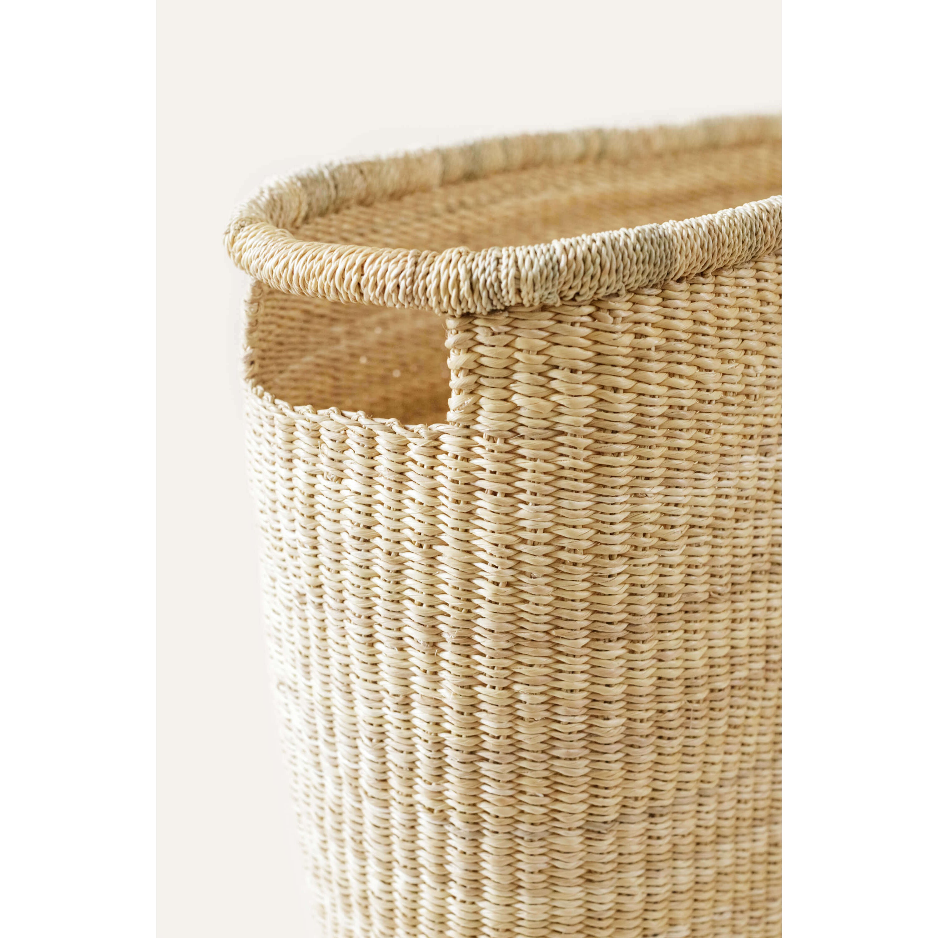 Woven basket with natural finish on a white background
