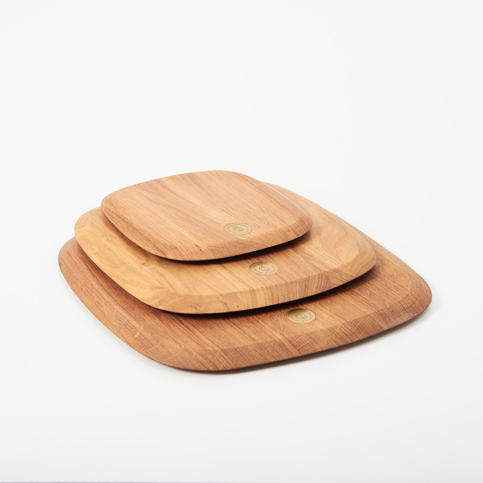 Set of three wooden serving boards of different sizes on a white background