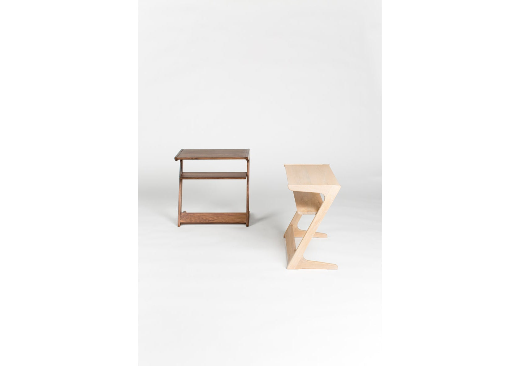 Two wooden stools on a white background