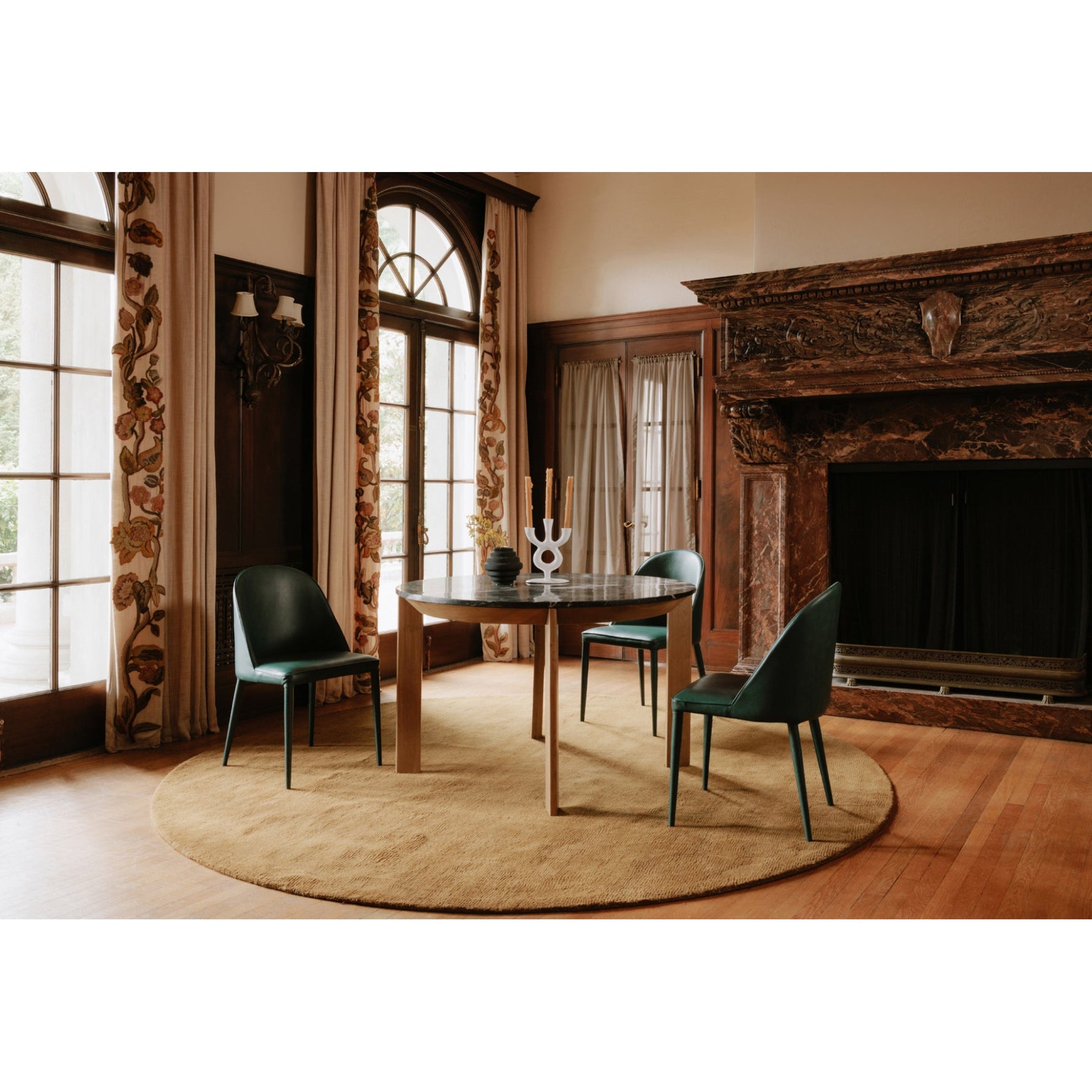 Dining room with wooden table and chairs in front of a fireplace