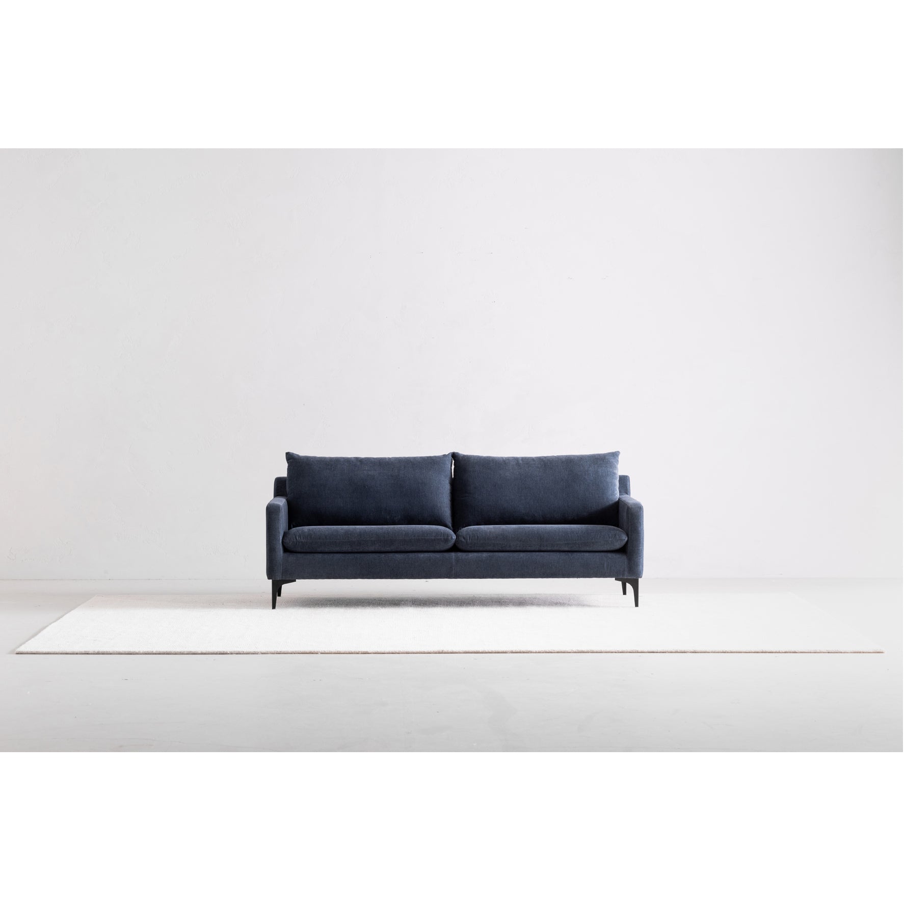 Navy blue sofa on a white background