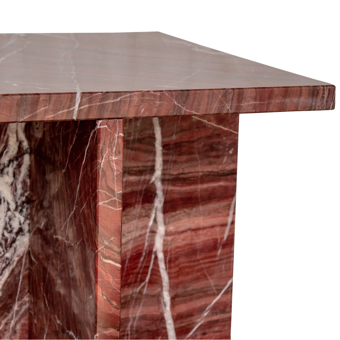 Red marble-patterned side table on a white background