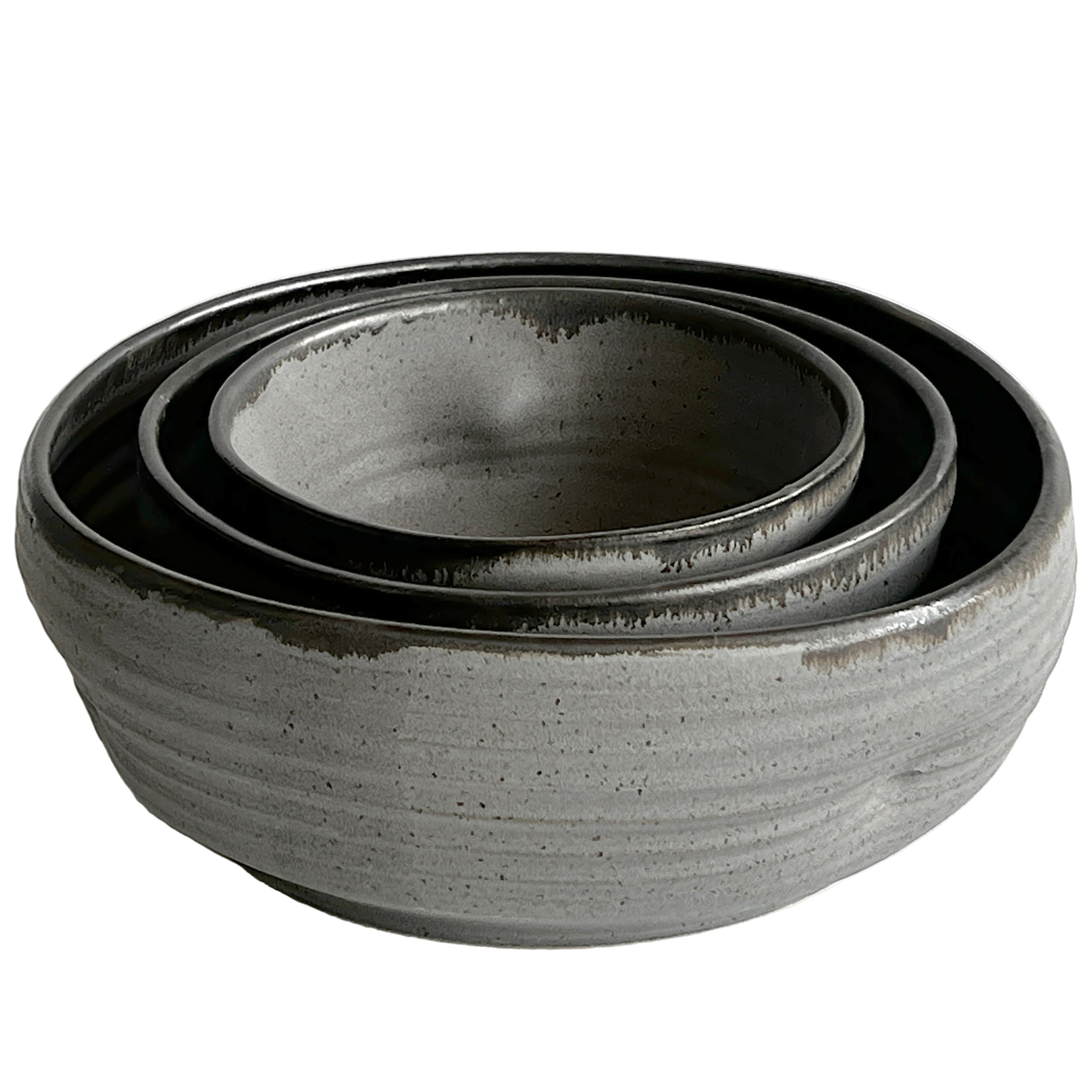 Set of three gray ceramic bowls on a white background