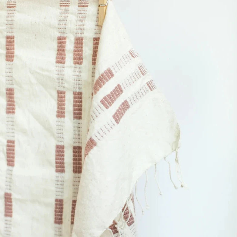 White hand towel with red stripes on a white background