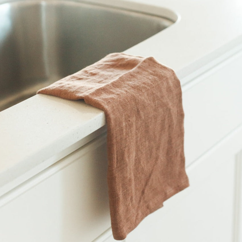Brown towel draped over a sink