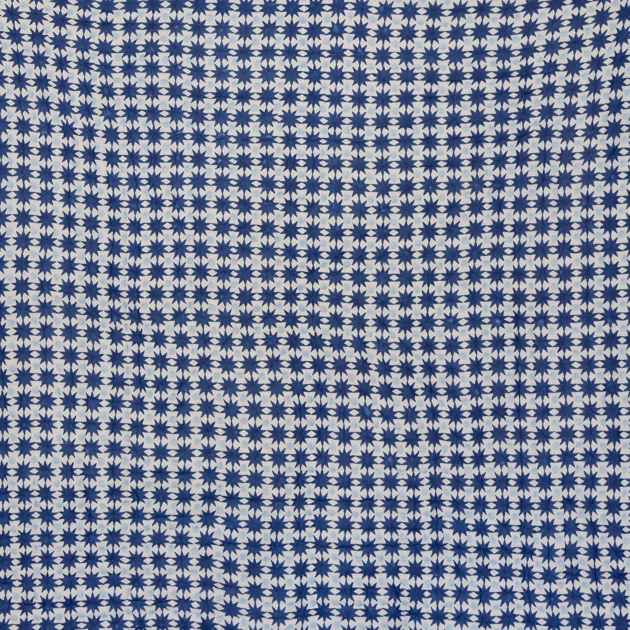 Blue and white checkered fabric on a light gray background