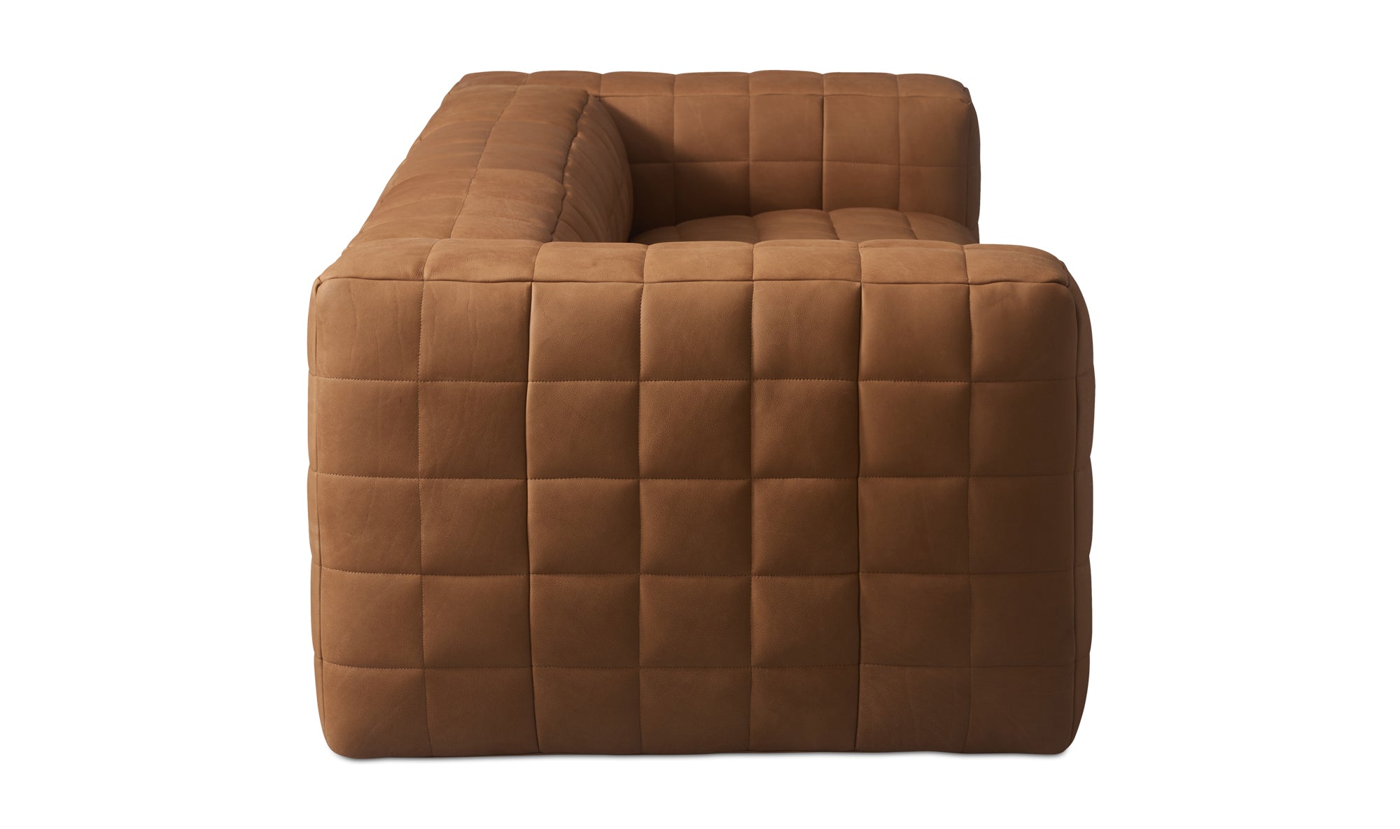 A brown leather Callan sofa with a modern silhouette, wide arms, and a low profile.