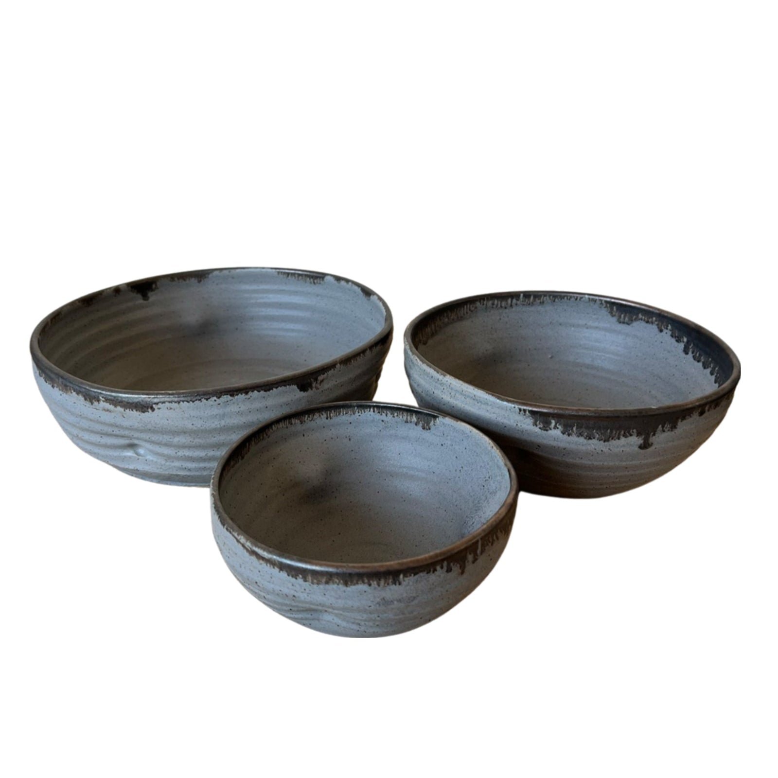 Three ceramic bowls with a textured finish on a white background