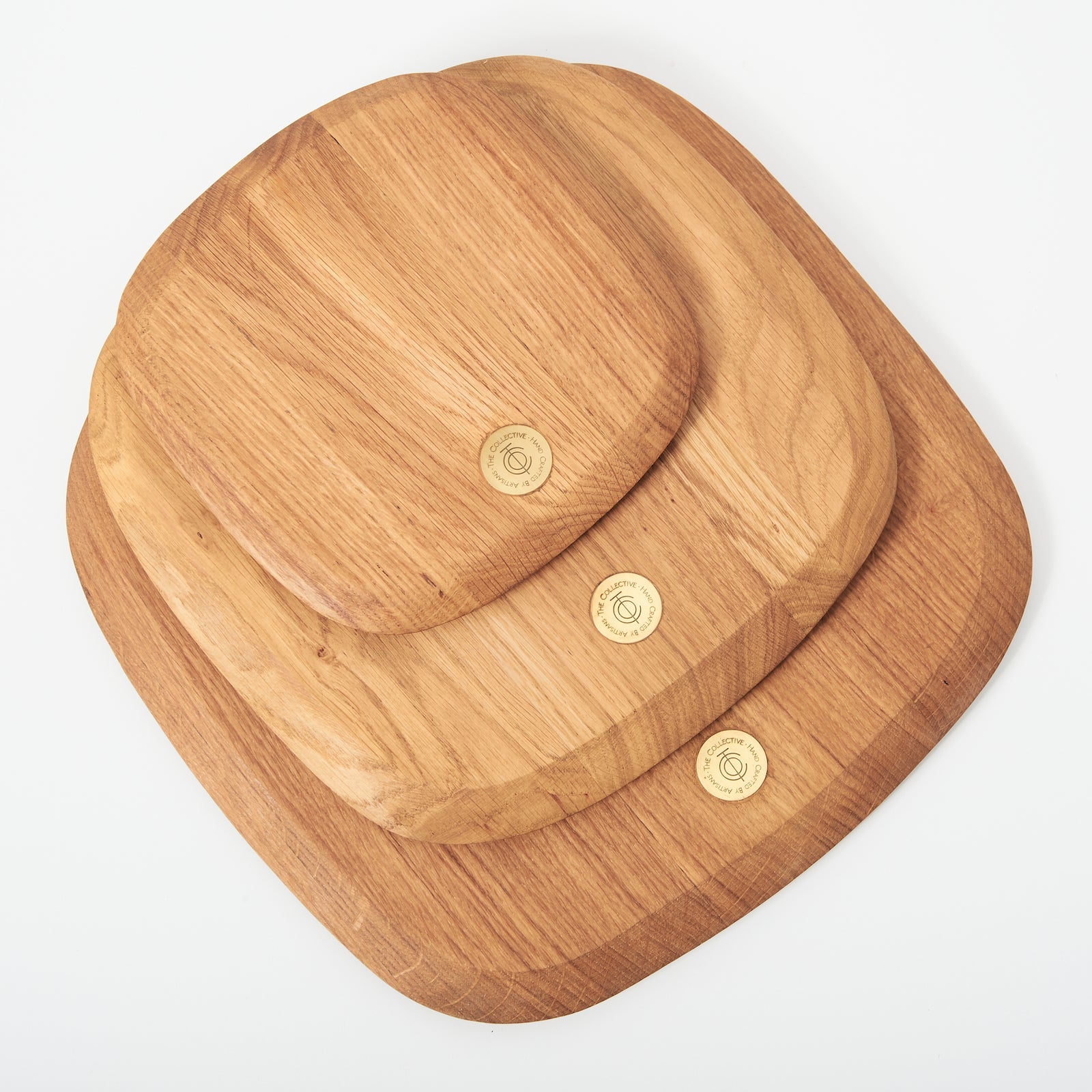 Three wooden serving boards of various sizes stacked upon one another